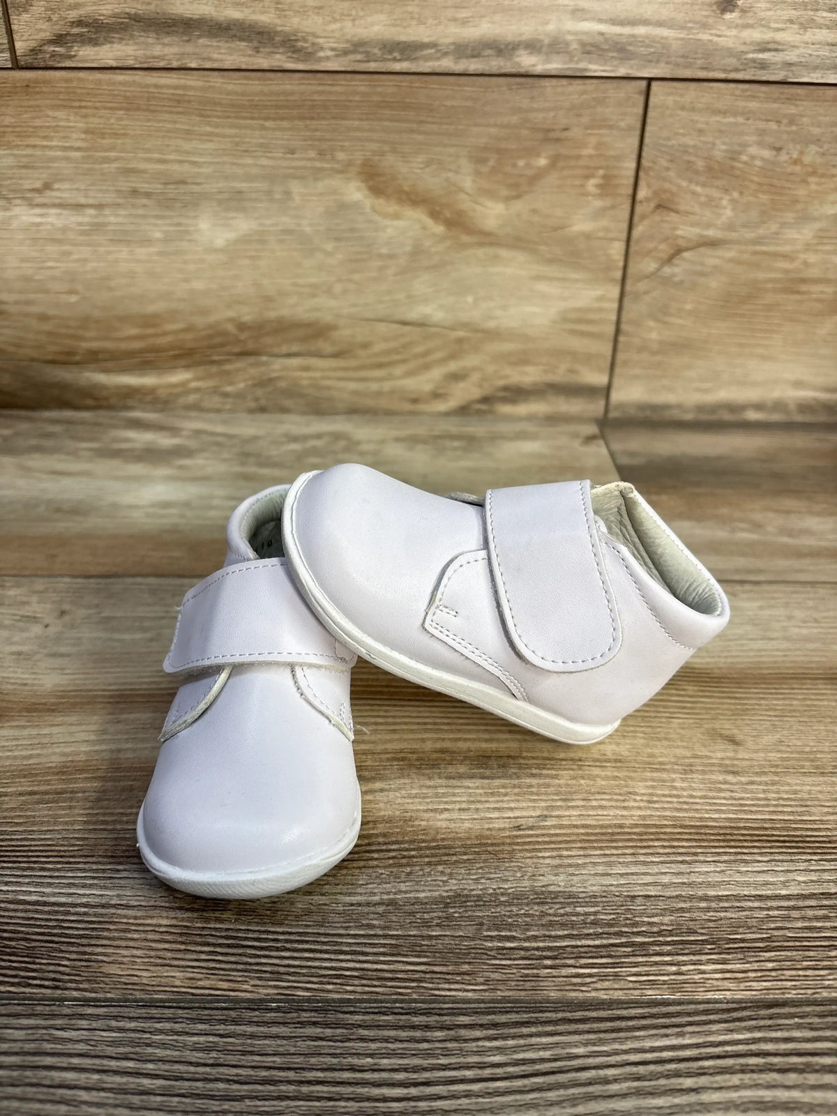 Pair of white Alegria Kids patent leather first walker shoes with hook-and-loop straps.