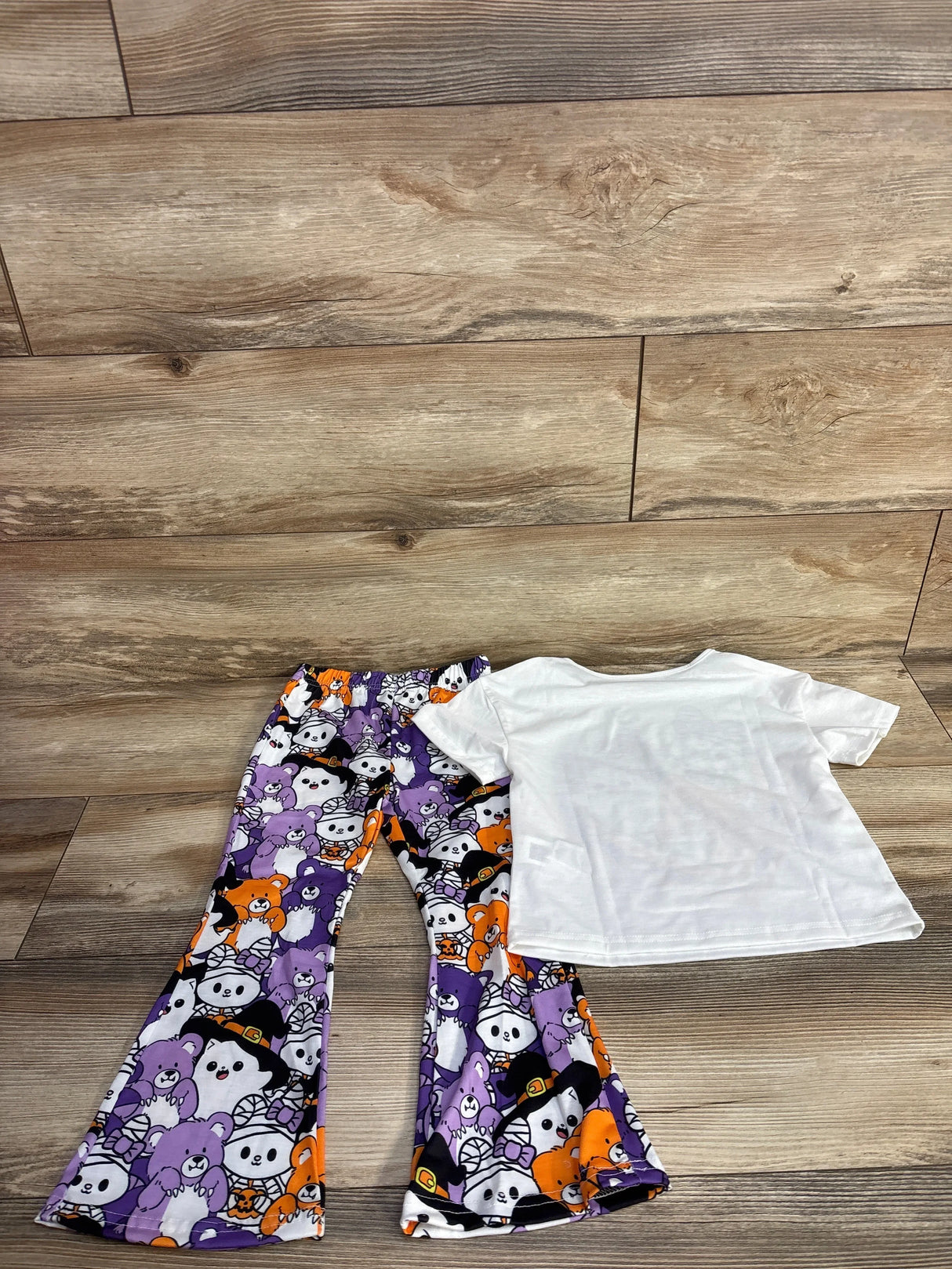 Halloween-themed kids outfit with purple and orange bear print pants and white tee