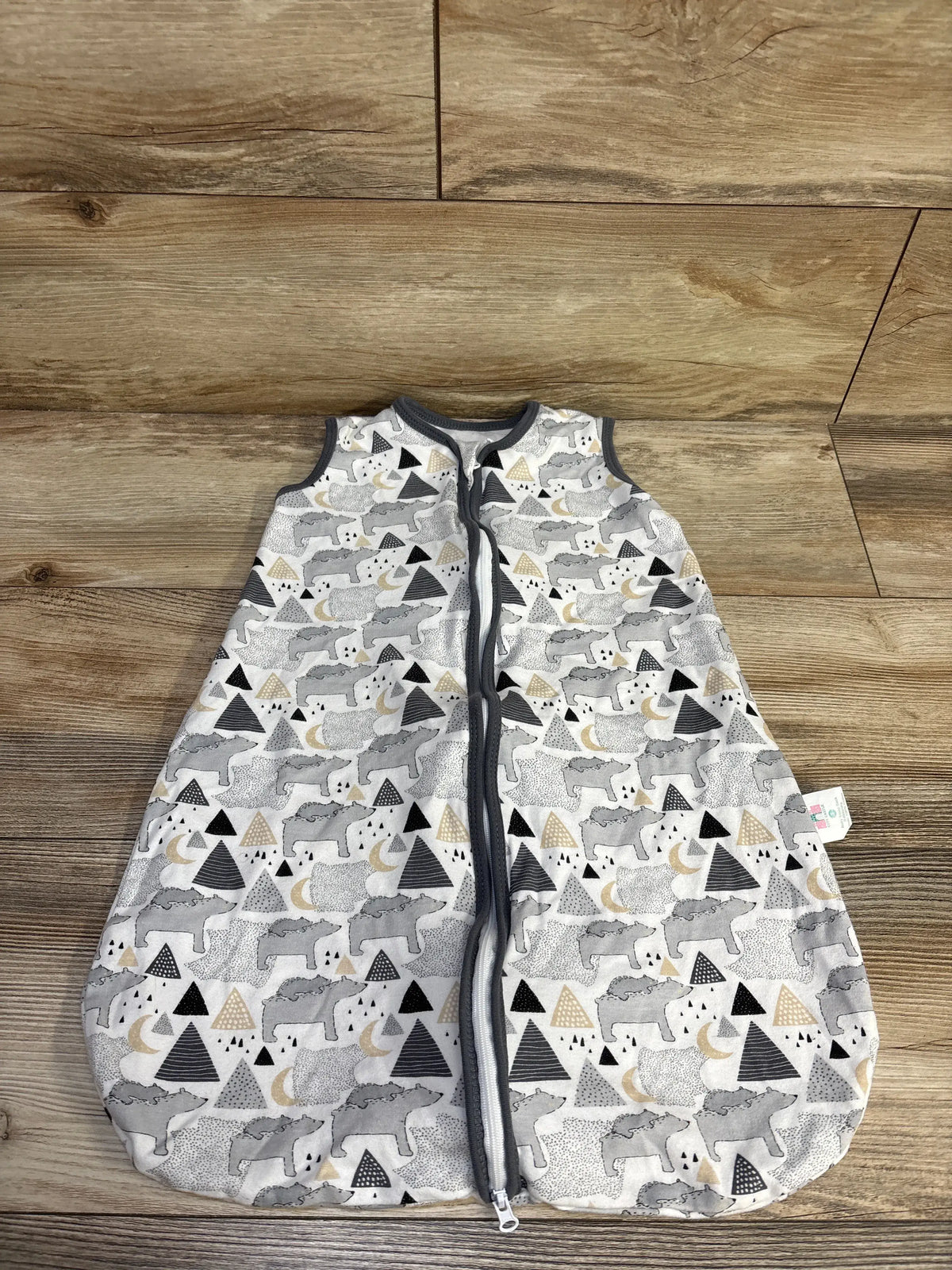 Front view of Cute Castle sleep sack showcasing a full length zipper and patterned white cotton fabric on a wood floor