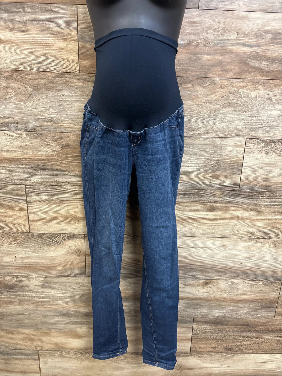 Front view of 1822 denim maternity jeans showing black over the bump panel and straight leg blue denim on wood background