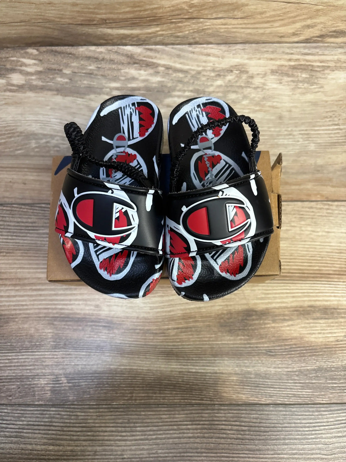 New Me n Mommy To Be black comic print slide sandals with red accents