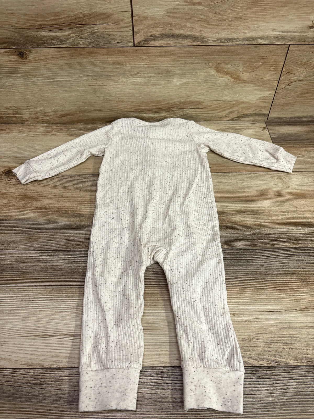 Front view of Carter’s ivory ribbed Henley coverall showcasing long sleeves and cuffed legs on a wood background