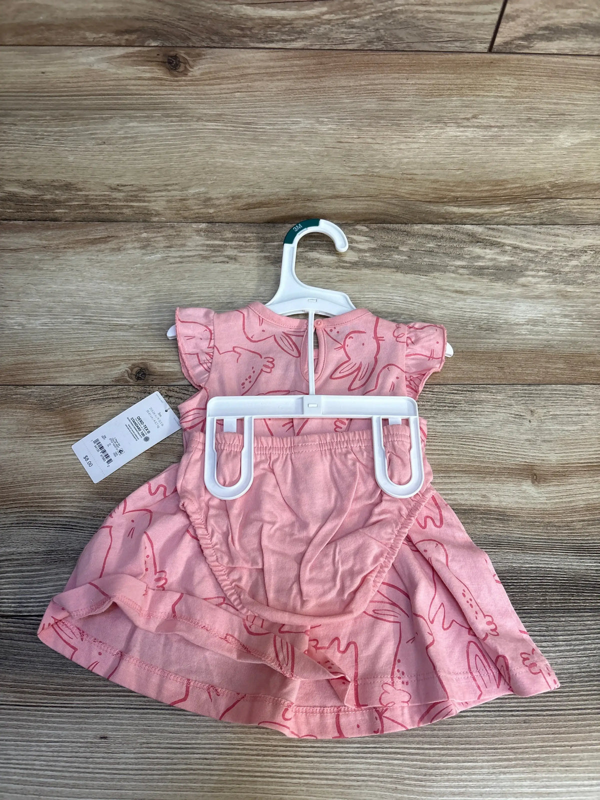 Pink baby dress with bunny print, size 3M, on hanger for resale