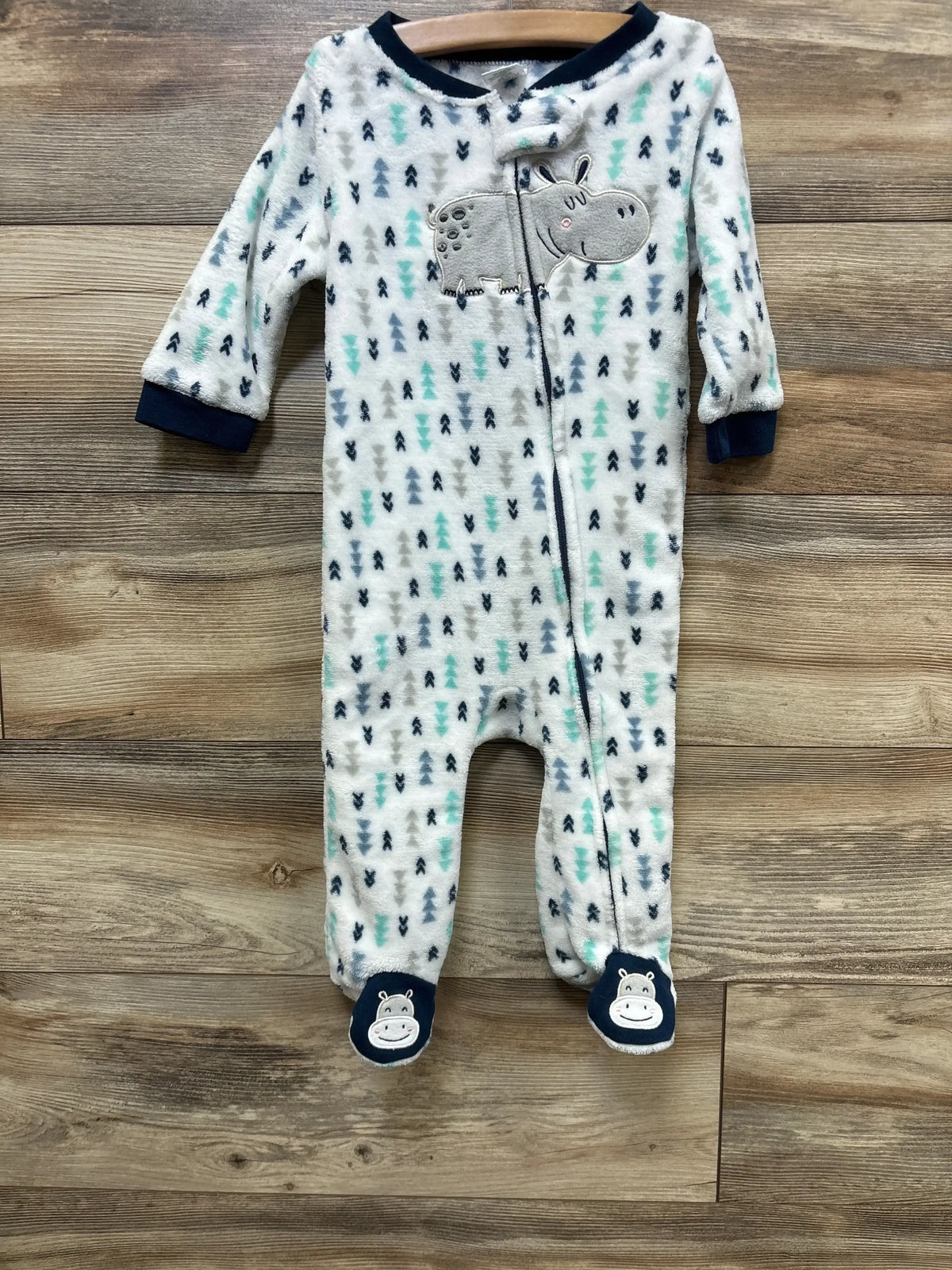 Soft baby onesie with hippo appliqué, tree print, and footies, ideal for infant sleepwear or cozy baby clothes.