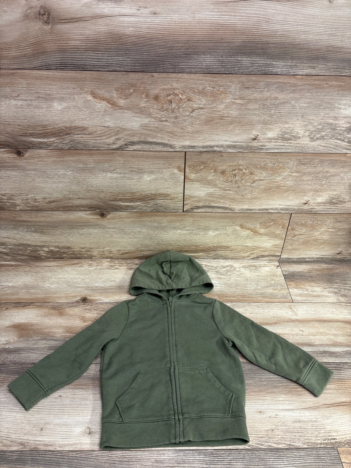 Front view of green Old Navy zip hoodie in toddler size 3T showcasing hood, full-length zipper, and front pockets with wood plank background
