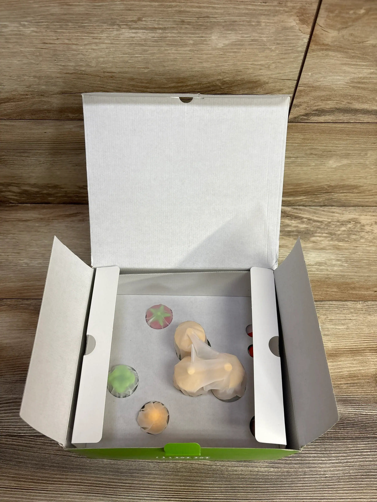 Top view of NEW BanBan’s Farm Puzzle showcasing colorful pieces in an open white box on a wood floor
