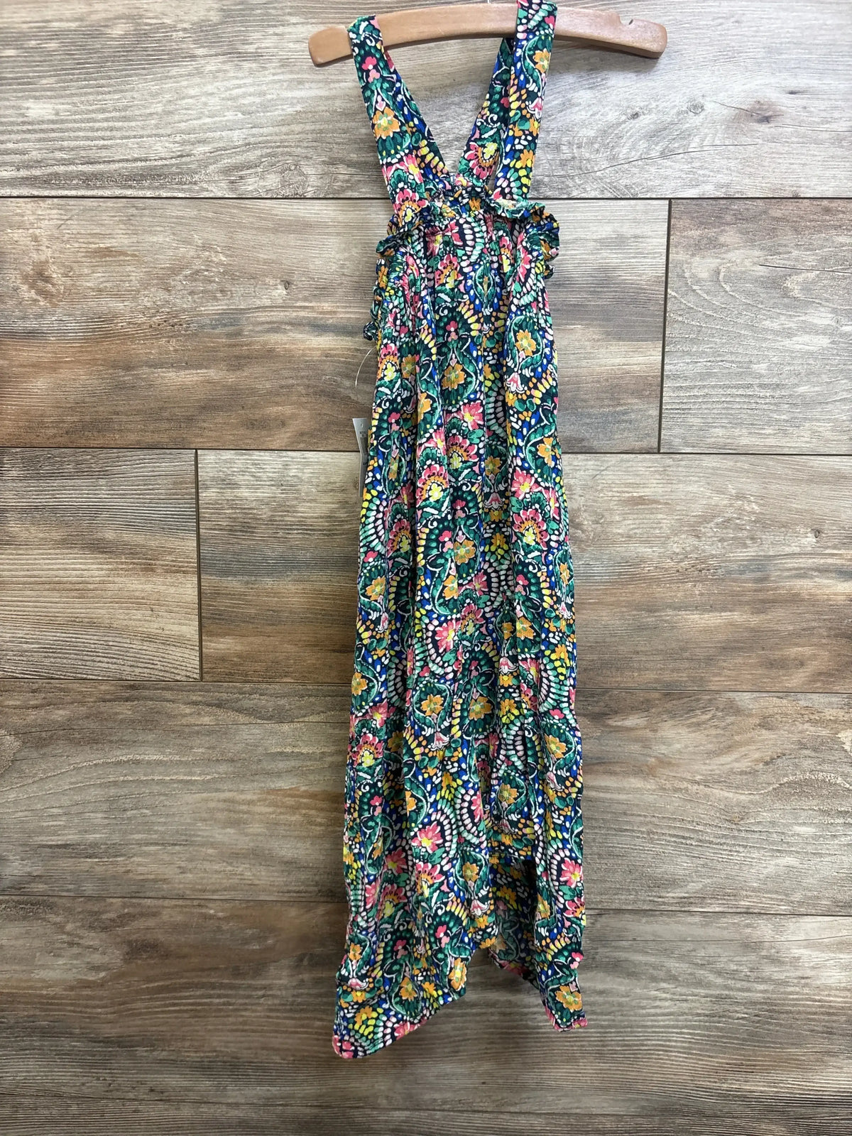 Front view of multicolor Old Navy floral tank dress size 5T with ruffle bodice on wooden hanger against wood background