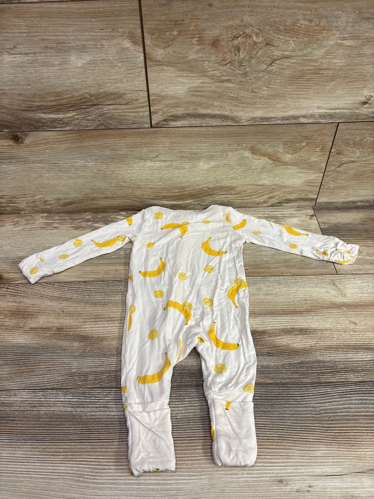Top view of Carter’s PurelySoft x Once Upon A Farm ivory sleeper, size 3m, with yellow fruit print and covered feet