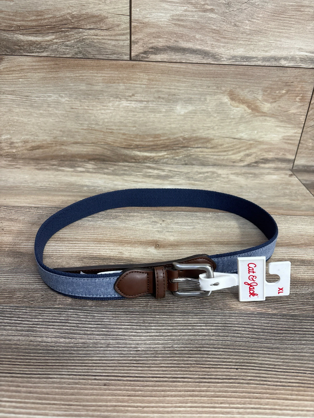 Cat & Jack kids navy and denim belt with silver buckle on wooden background size XL