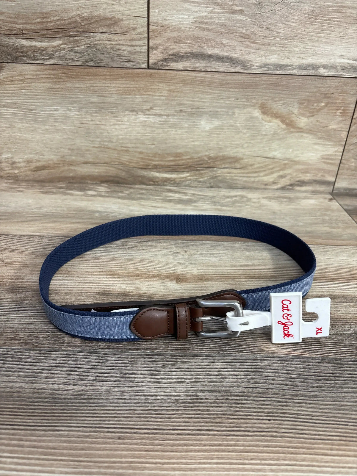 Cat & Jack kids navy and denim belt with silver buckle on wooden background size XL