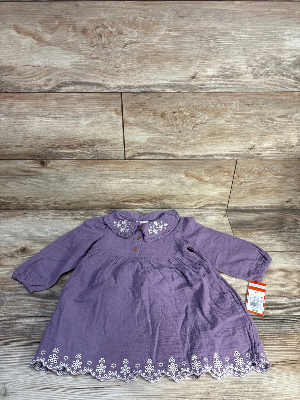 Flat lay of mauve Cat & Jack gauze toddler dress (2T) showing embroidered scalloped hem and Peter Pan collar on wood