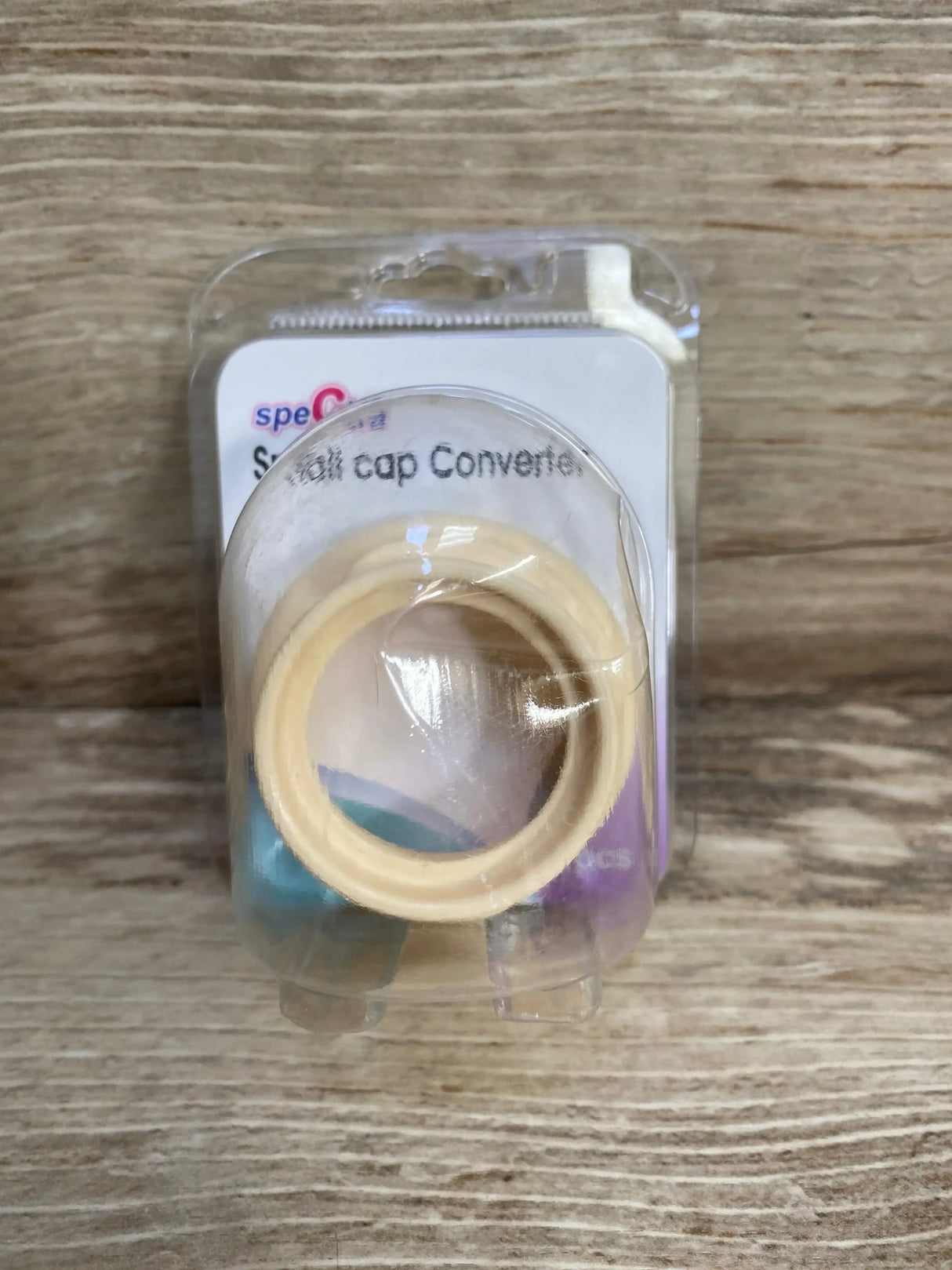 Front view of Spectra small-to-wide neck bottle cap adapter showing threaded adapter ring on white background