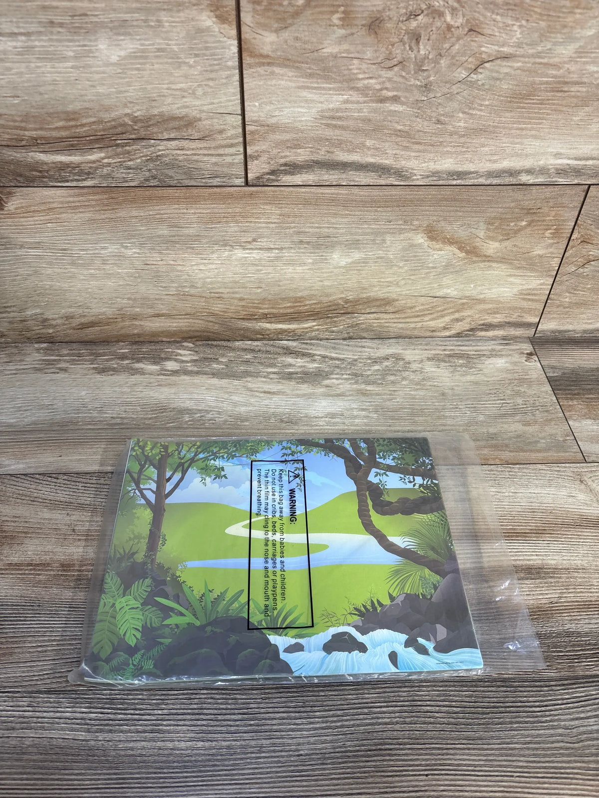 Top view of zoo sticker scene pack showing 12 sticker sheets in sealed plastic with illustrated jungle scene on wood tabletop