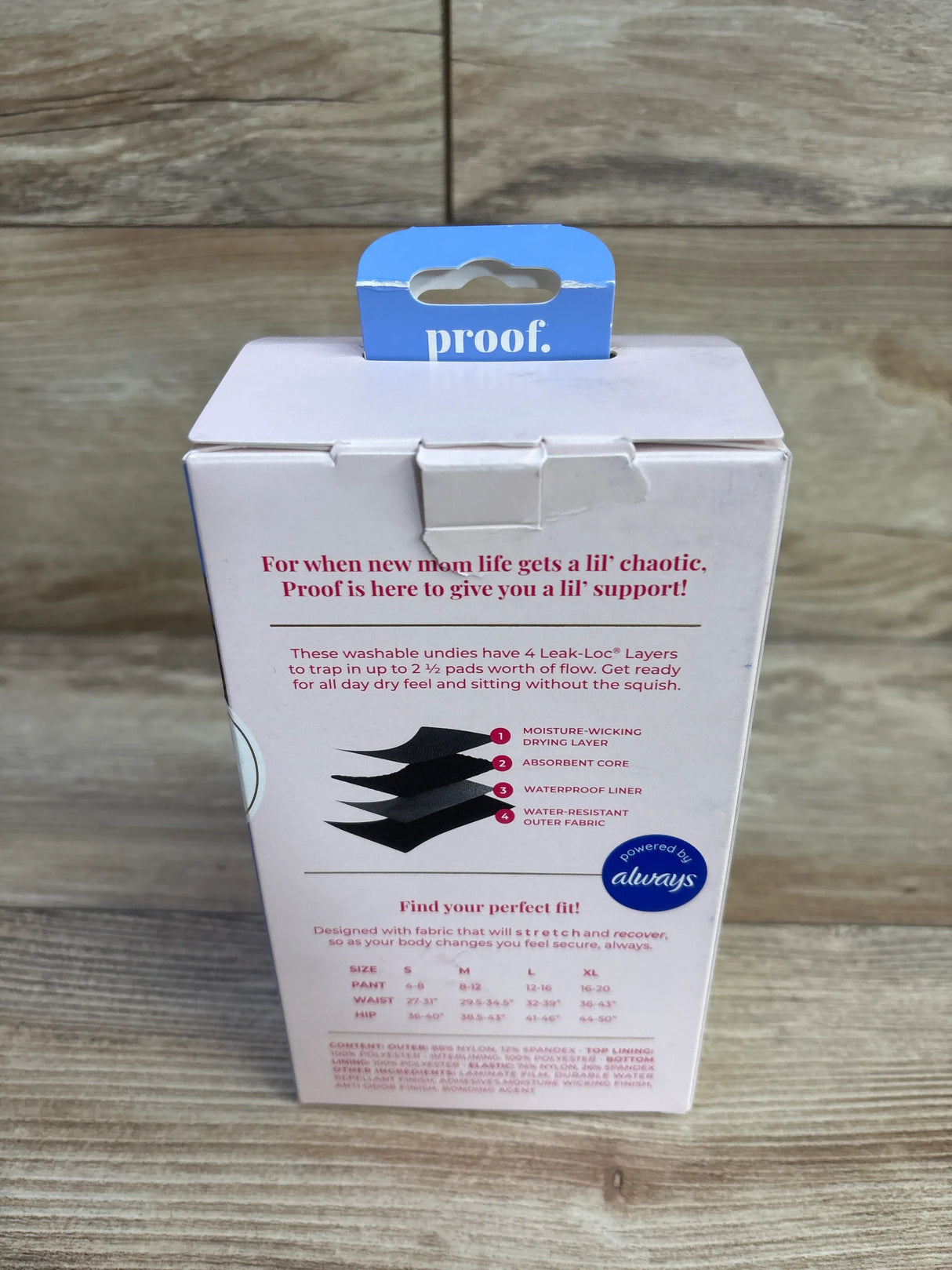 Rear view of Proof postpartum underwear box showing four-layer Leak-Loc diagram and size medium label on wooden surface