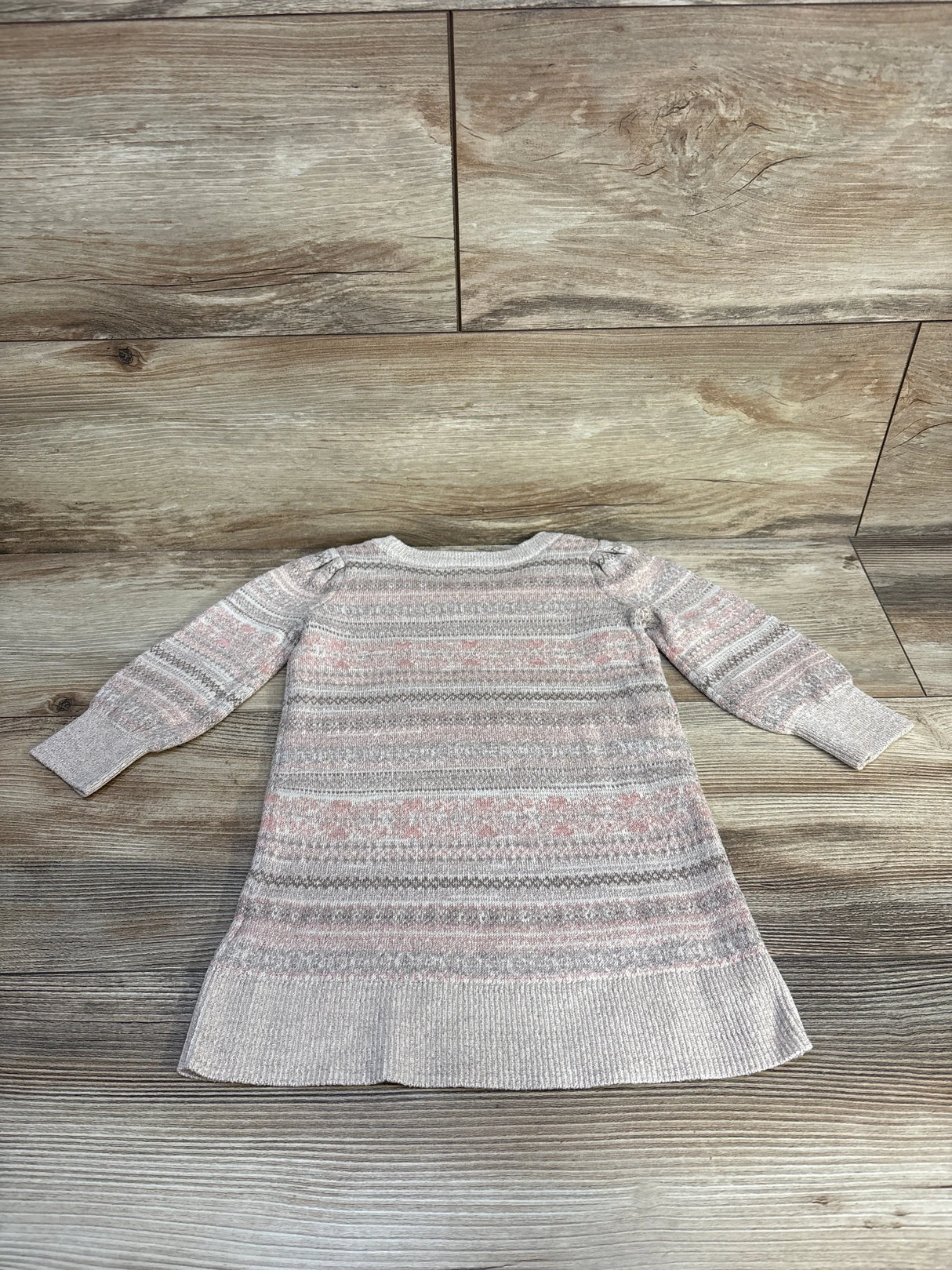 Flat-lay of Baby Gap metallic sweater dress, 18–24M, showing long sleeves and pink-gray Fair Isle pattern on wood background