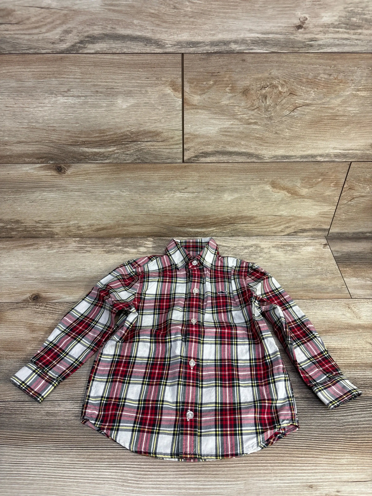 Red plaid long sleeve button-up shirt on wood floor