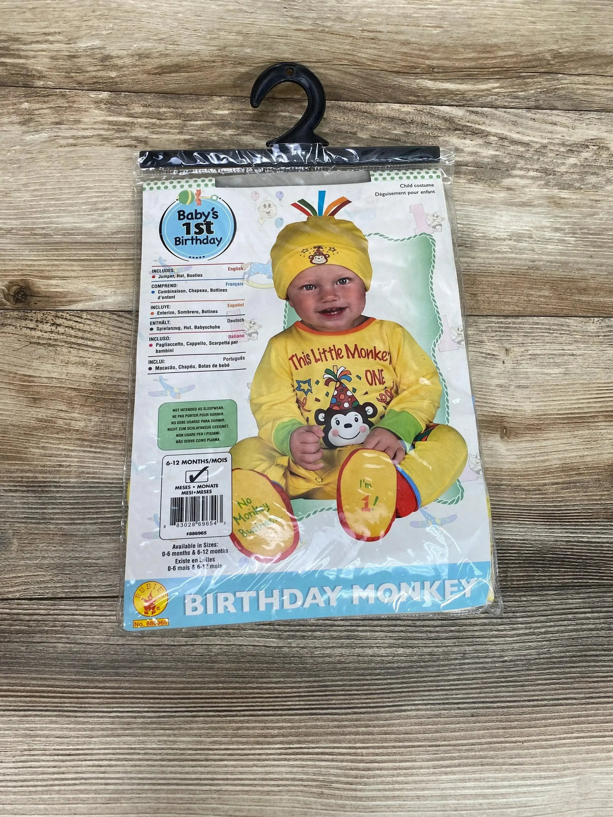 Front view of Birthday Monkey costume in packaging showing a yellow jumper, hat, and booties for 6 to 12 months