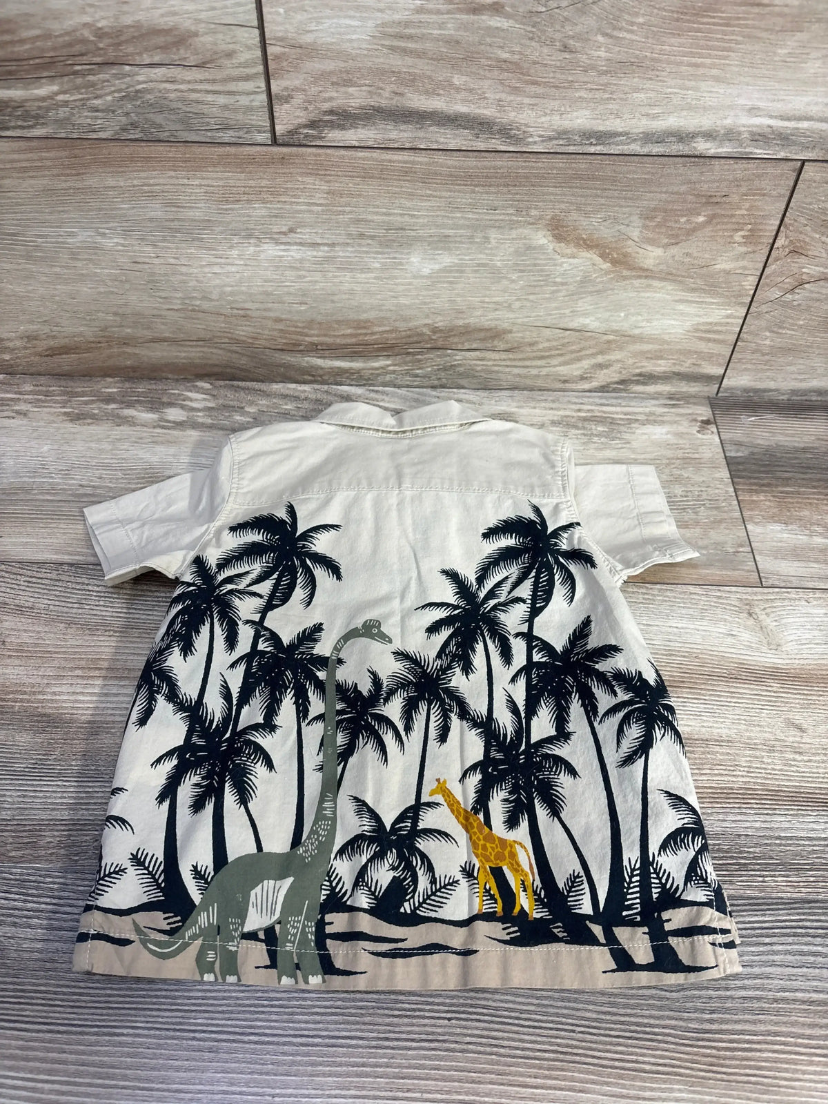 Back view of Old Navy beige button-up shirt for ages 12 to 18 months with palm trees, dinosaur and giraffe print