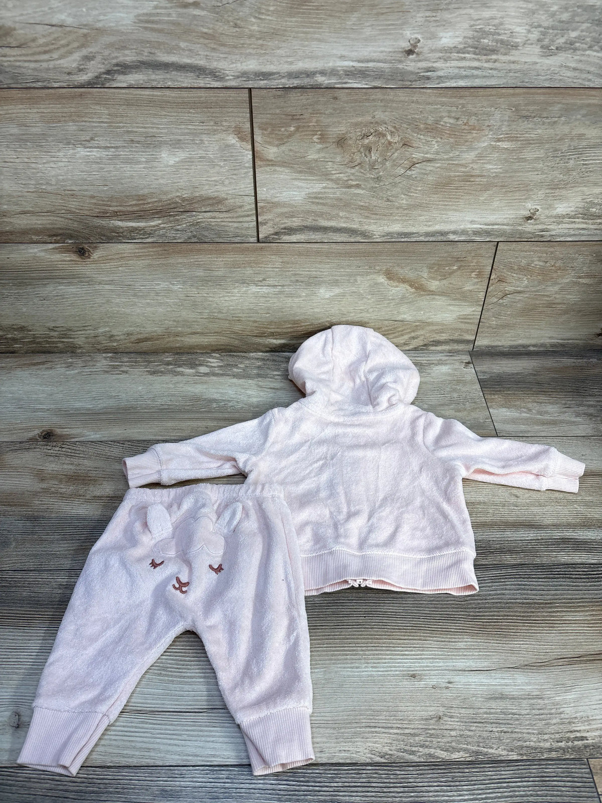 Flat lay of Carter’s 2-piece pink terry cloth full-zip hoodie and joggers set, showing the hood and elastic cuffs