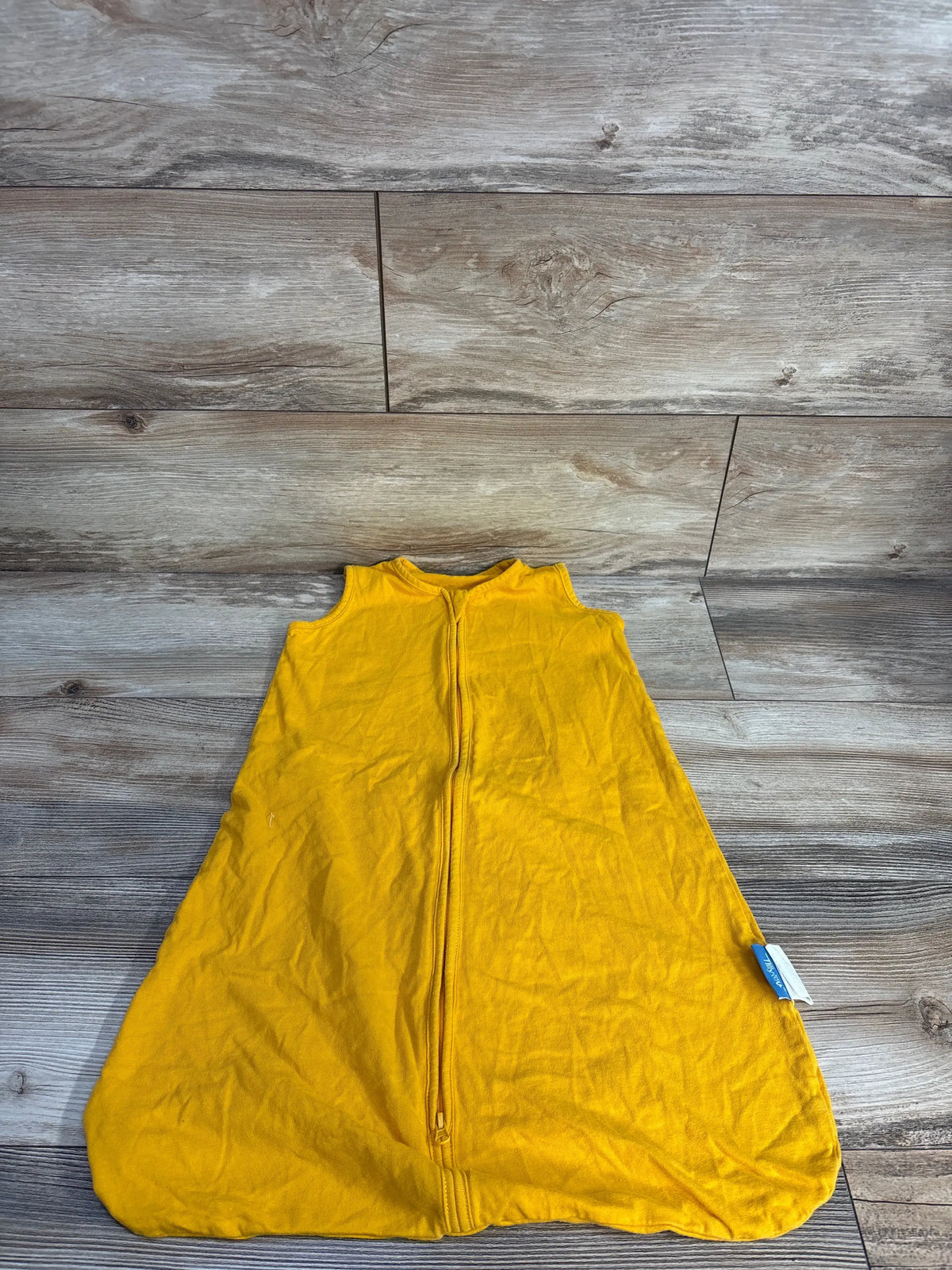 Front view of yellow Tillyou elephant sleep sack showcasing sleeveless design and two-way zipper on a wood floor