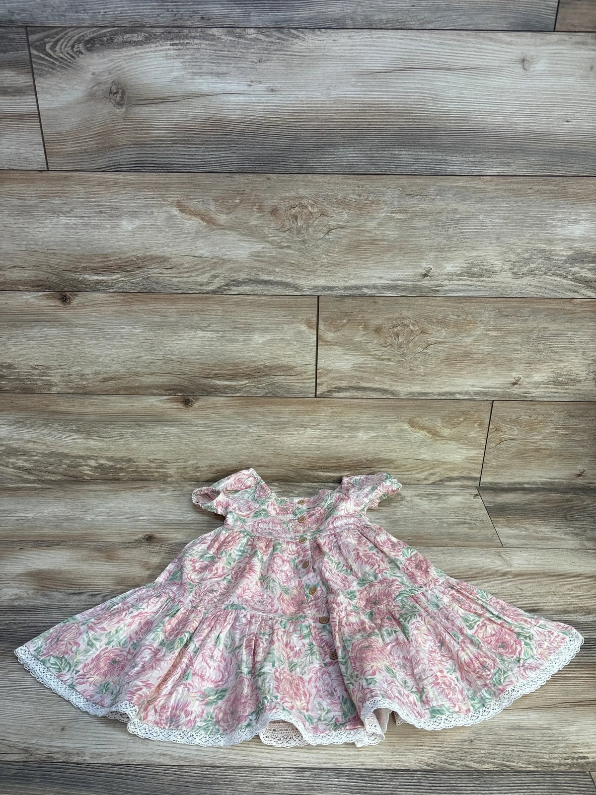 Front view of girls’ Joie floral button tiered dress in pink showcasing button closure and tiered skirt on white background