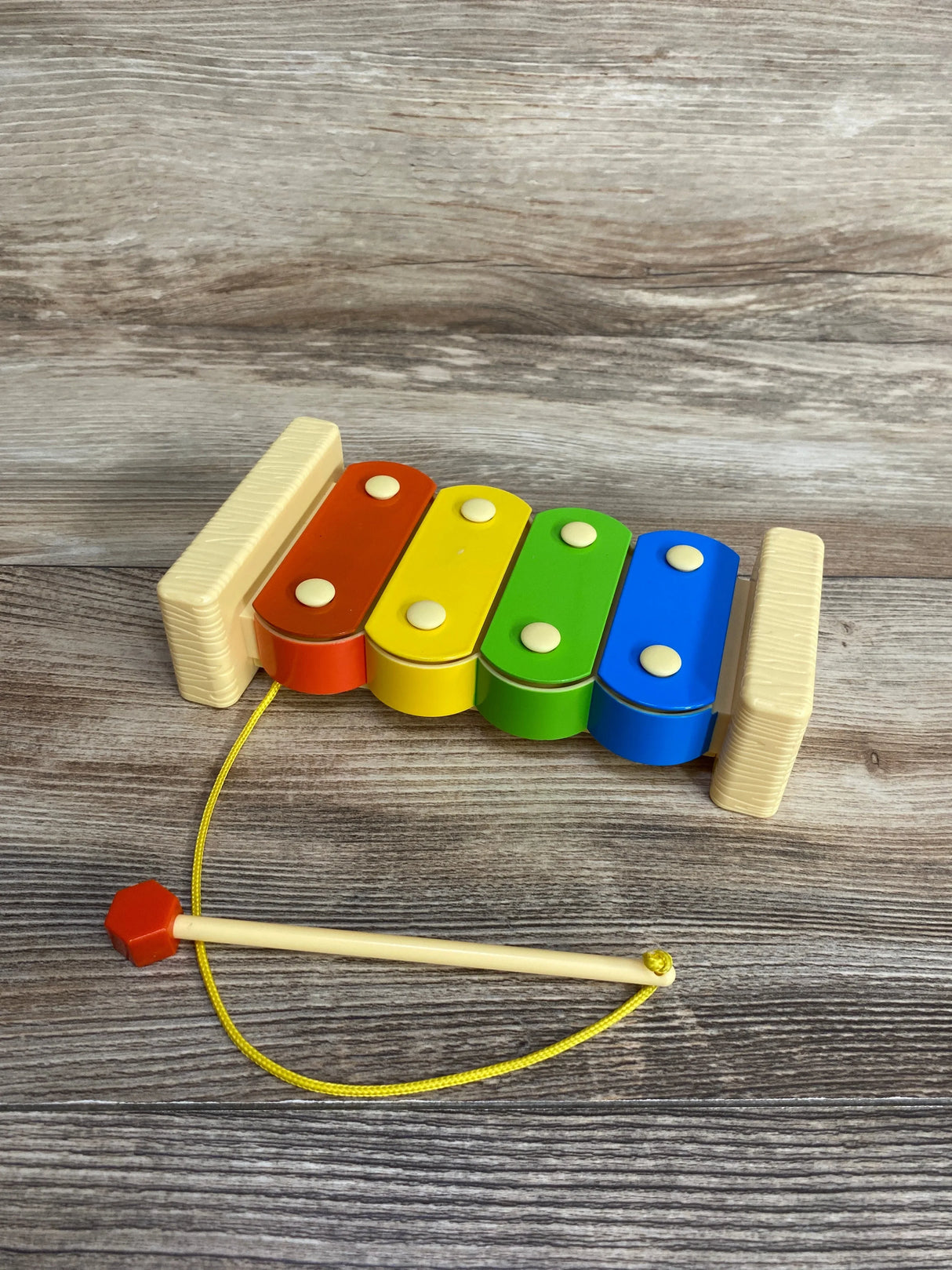Colorful wooden xylophone toy with mallet for kids on wood background