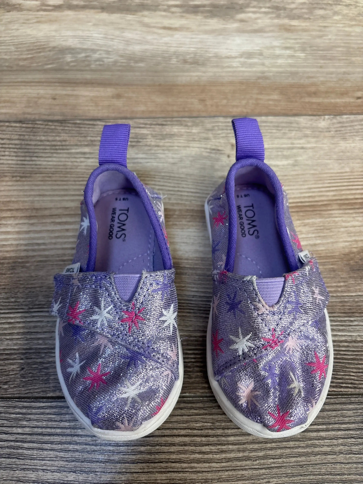 Purple Toms kids shoes with star print, slip-on design, and pull tabs for easy wear