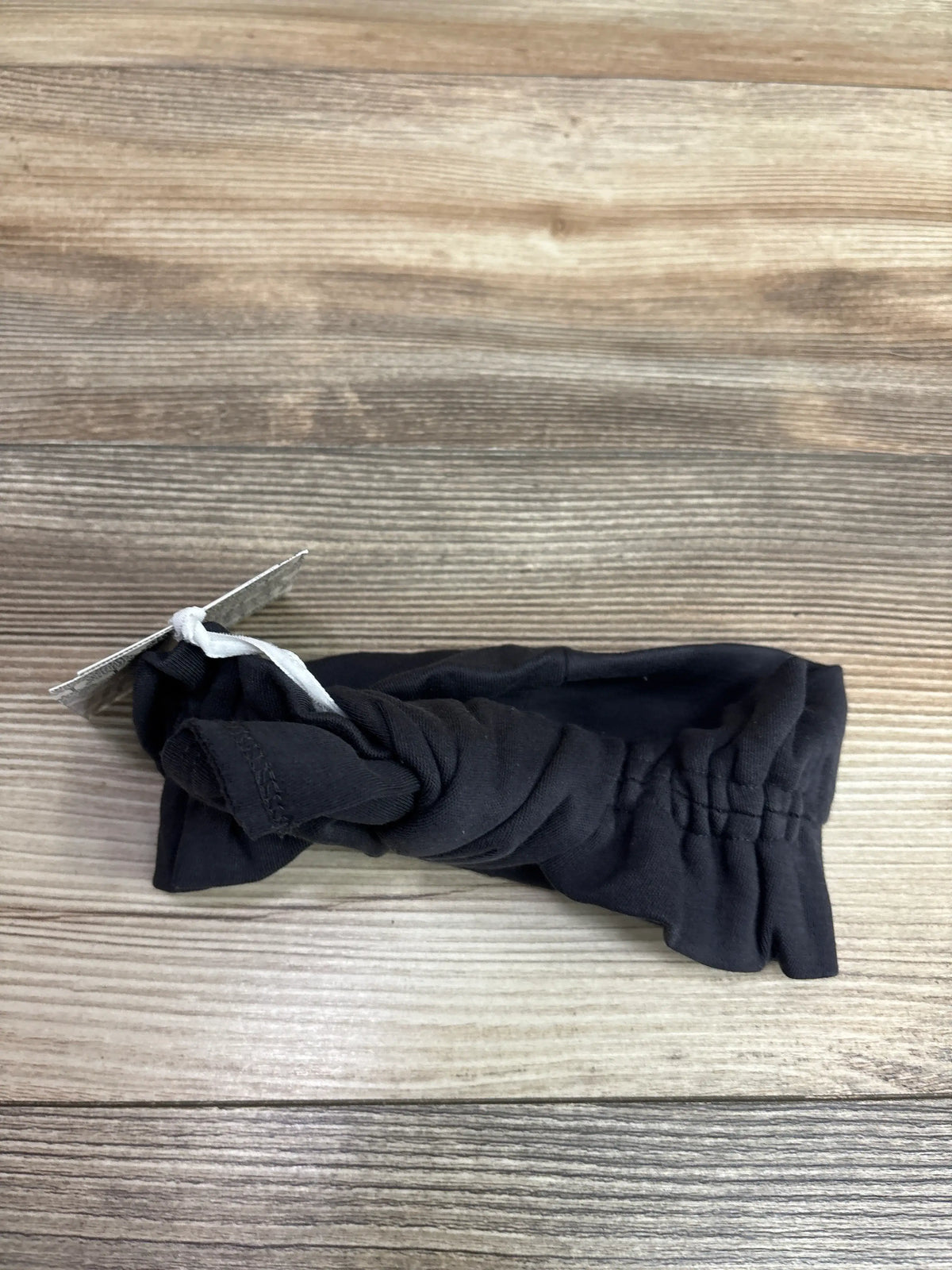 New grey stretchy bow headband by Me n Mommy To Be on a wooden background