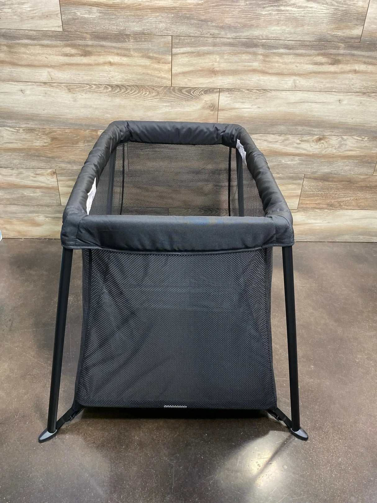 Front view of Dream On Me Travel Light playard in black showing mesh sides and collapsible frame on white background