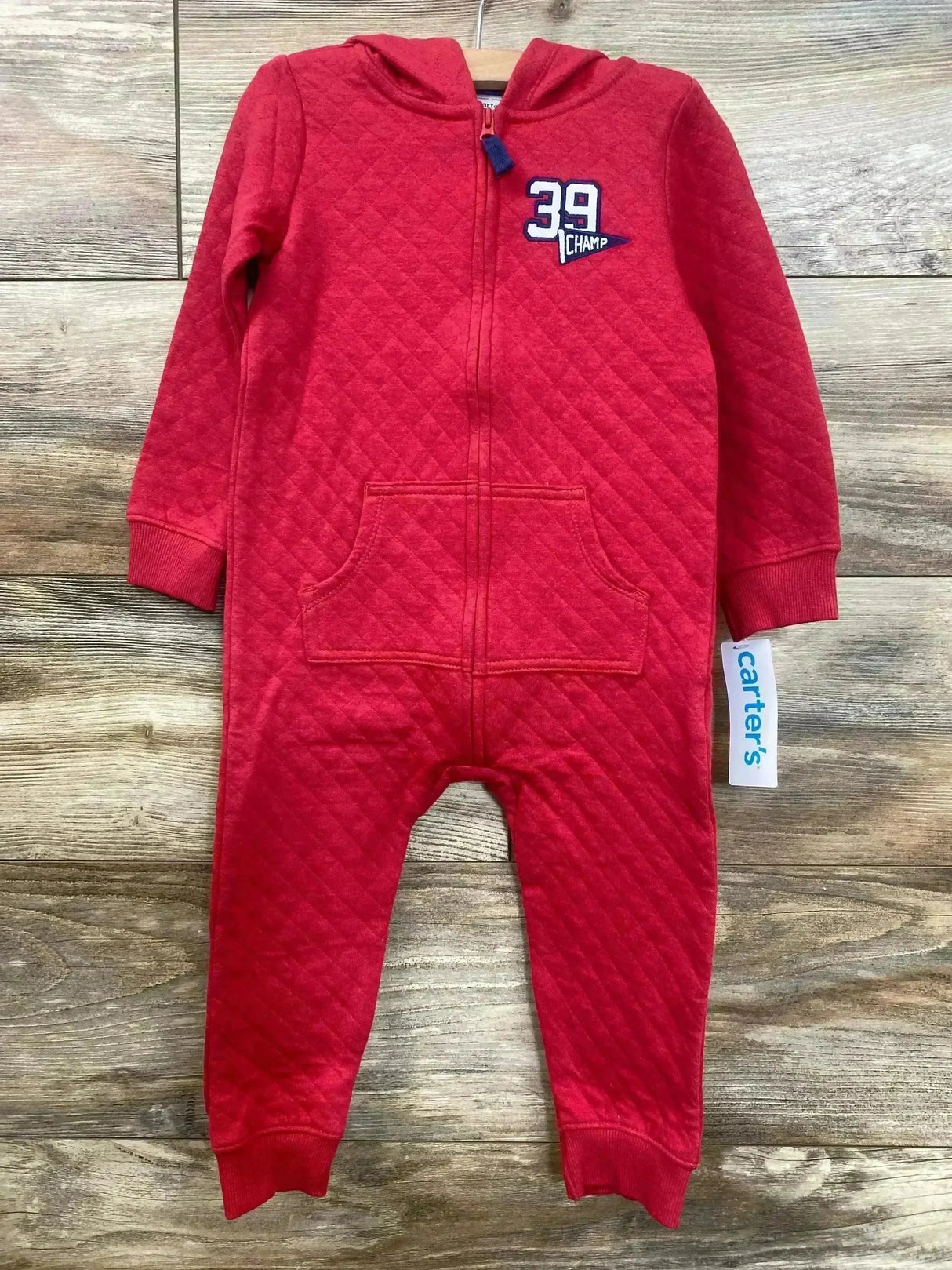 Front view of red quilted Carter's jumpsuit (24M) with hood, front zipper, kangaroo pocket and cuffed sleeves on wood floor