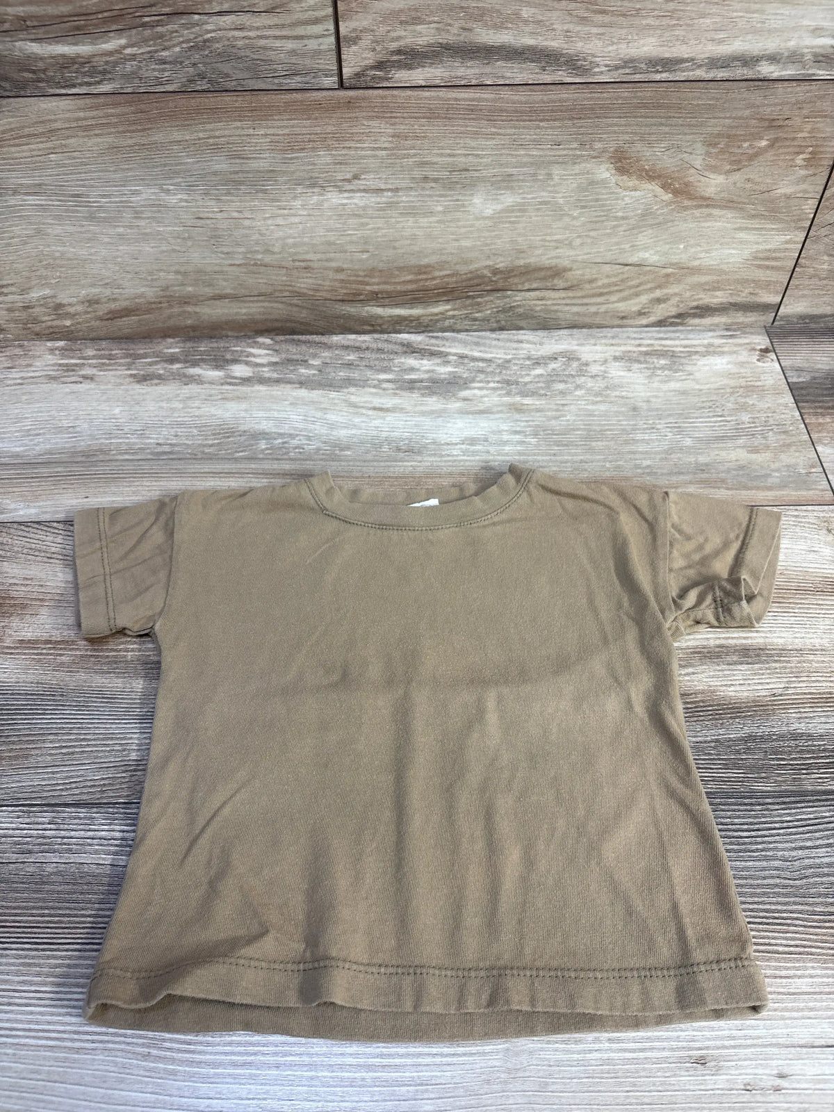 Front view of Silver Lake Cloth solid tan shirt showcasing short sleeves and crew neckline on a wood grain background