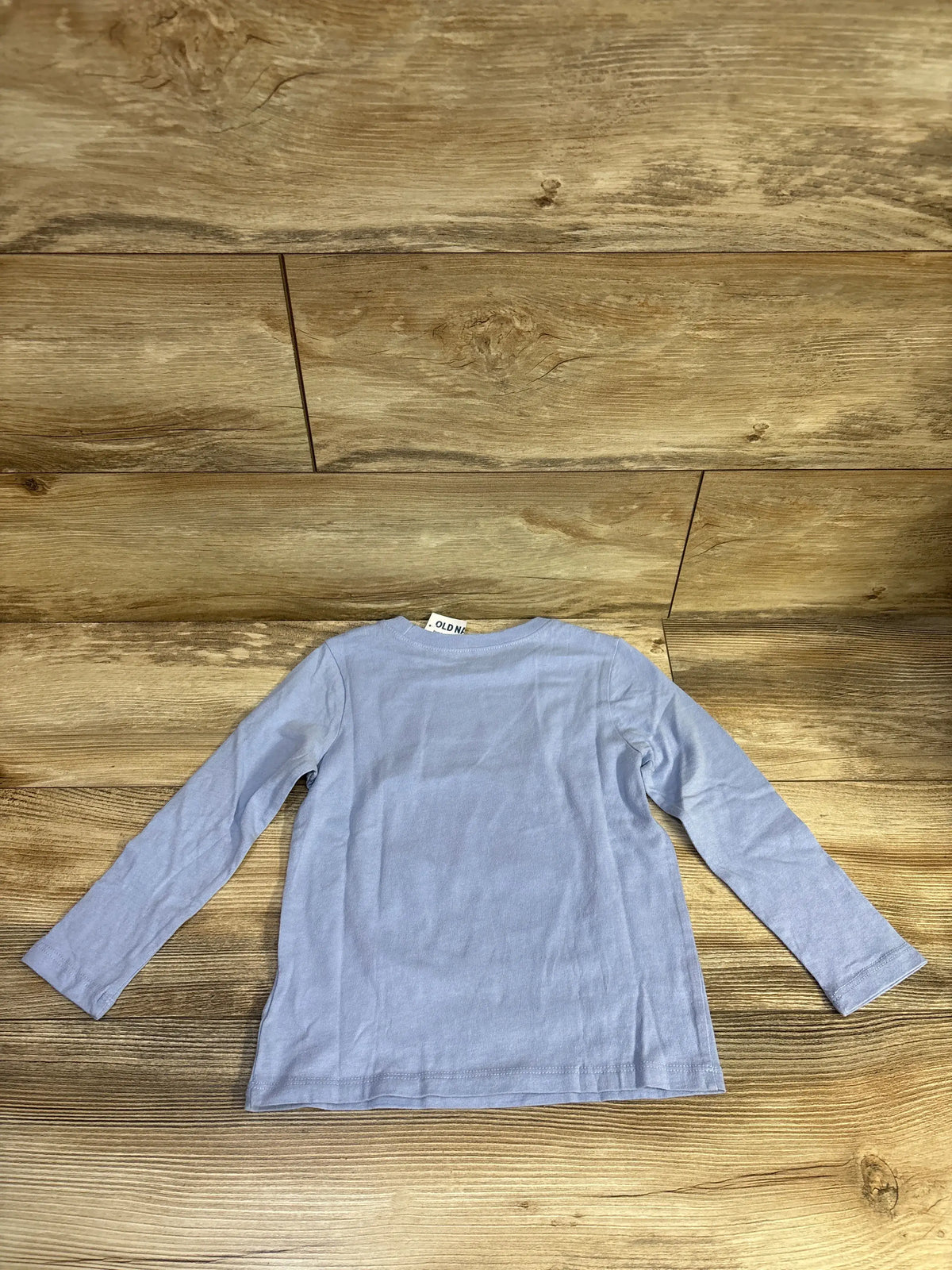 Back view of blue Old Navy Creepin’ It Real Halloween shirt in size 4T, showcasing long sleeves on a wood-grain background