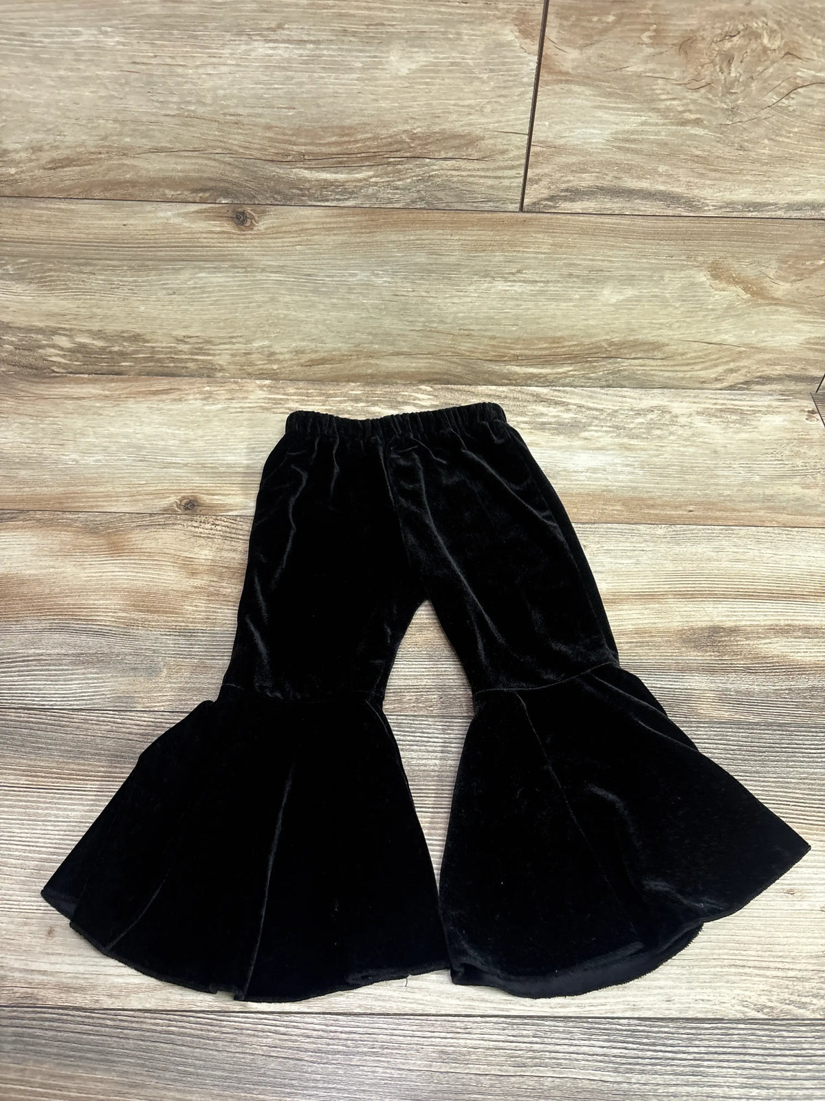 Black velvet bell bottom pants for toddlers by Me n Mommy To Be on a wood floor