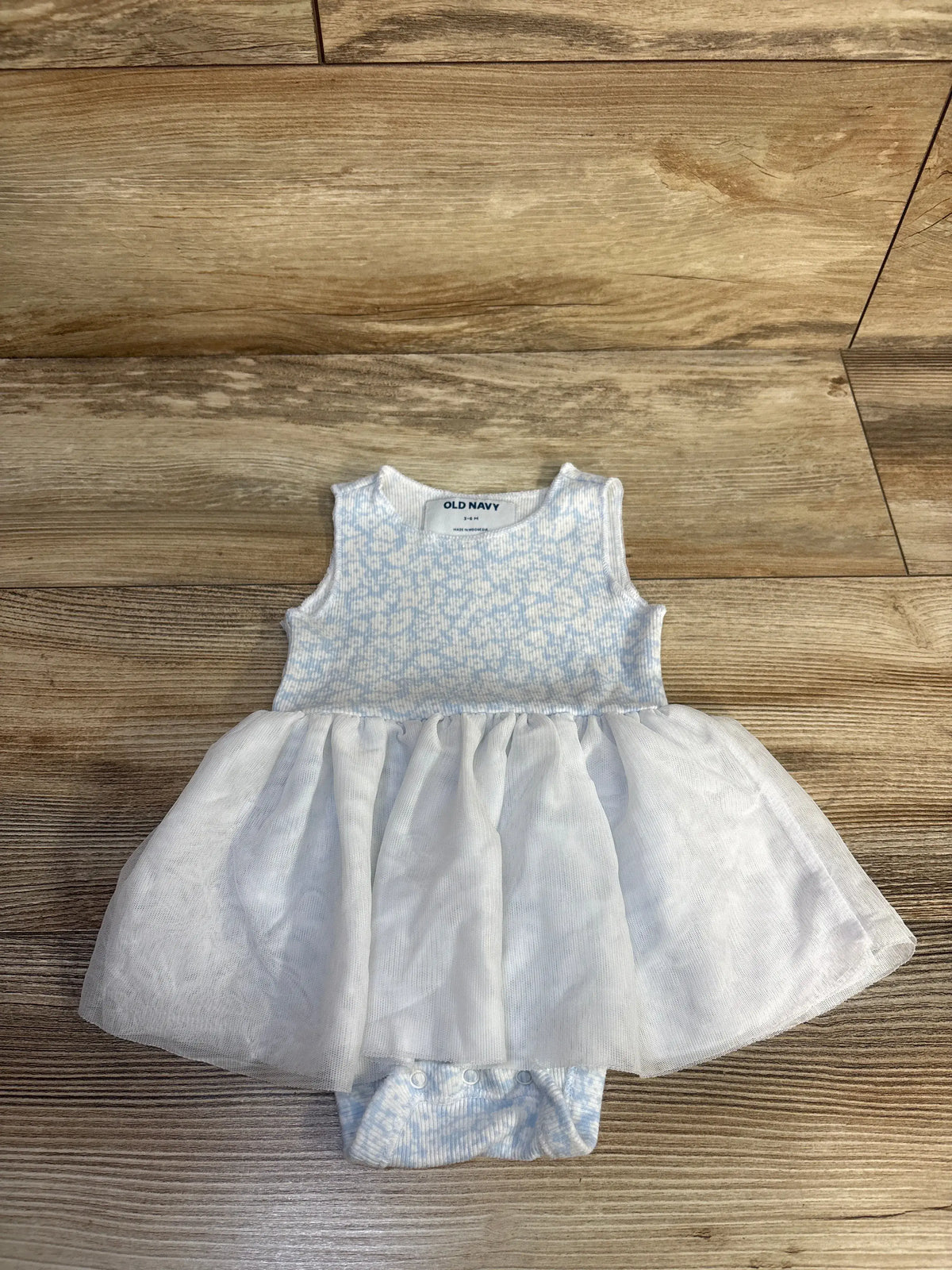 Old Navy ribbed tulle bodysuit dress in white and blue, size 3-6m, on a wood floor.