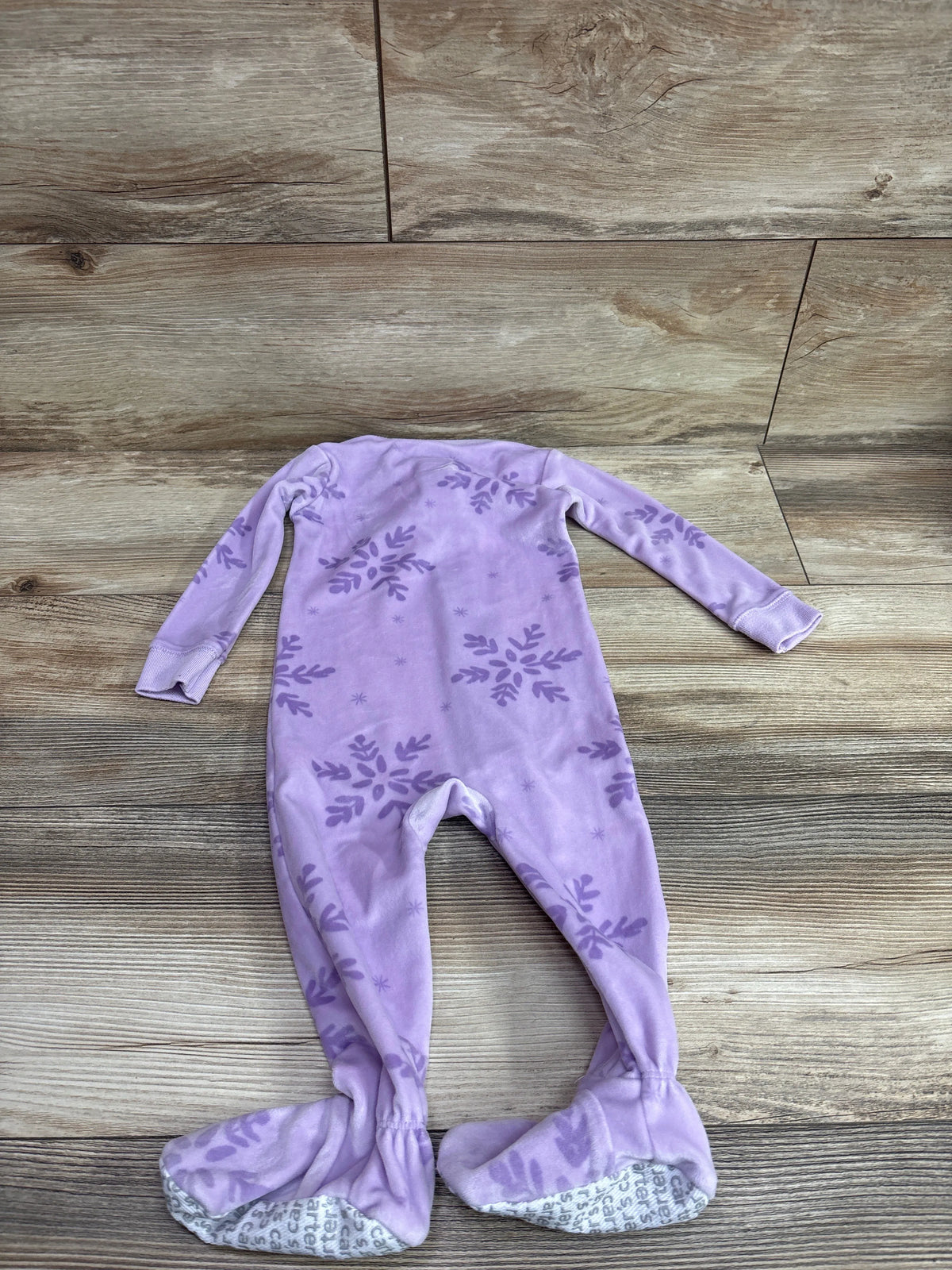 Top view of Just One You purple blanket sleeper with long sleeves, floral print, covered feet, and nonslip soles