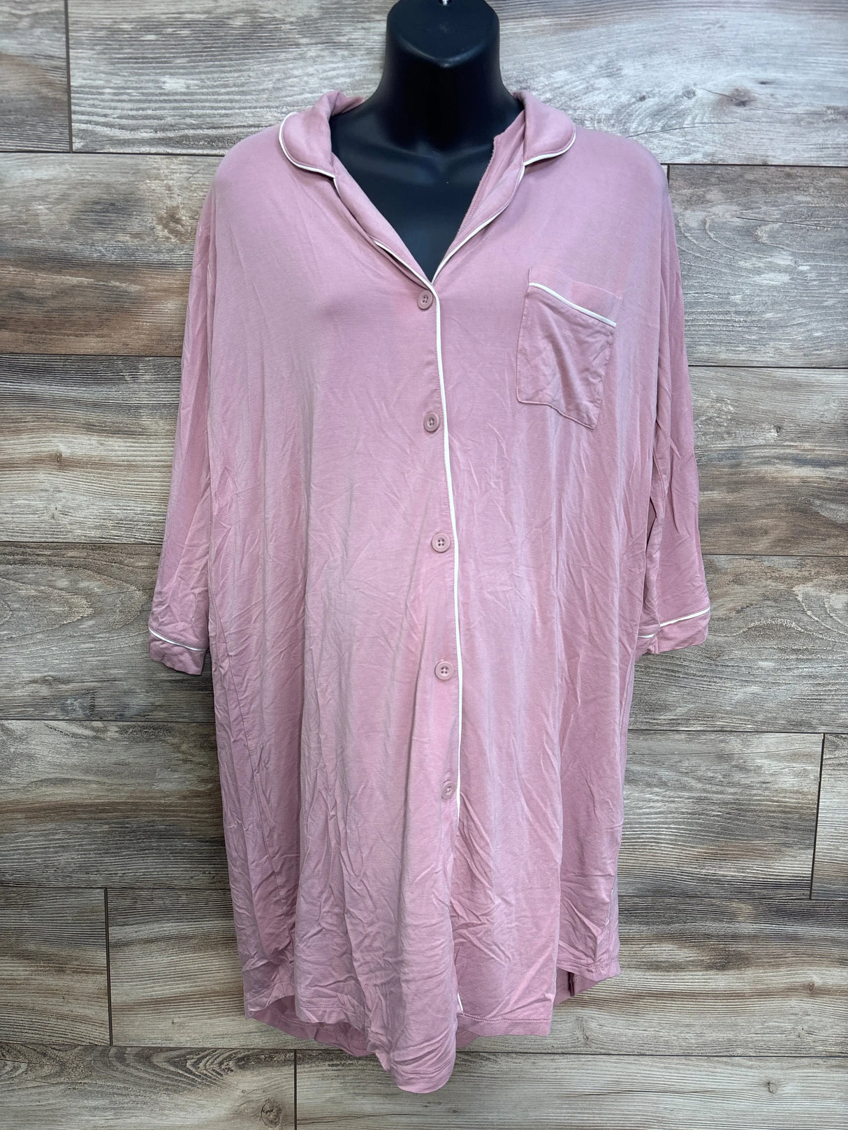 Front view of Caden Lane bamboo maternity nightgown in dusty pink, button front and chest pocket with white piping on wood