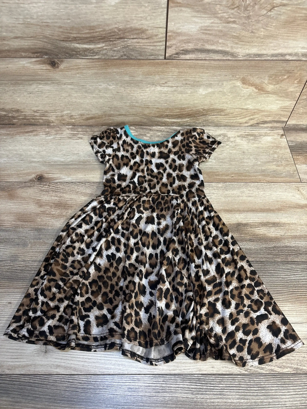 Girls' short sleeve leopard print dress with flared skirt on wood floor