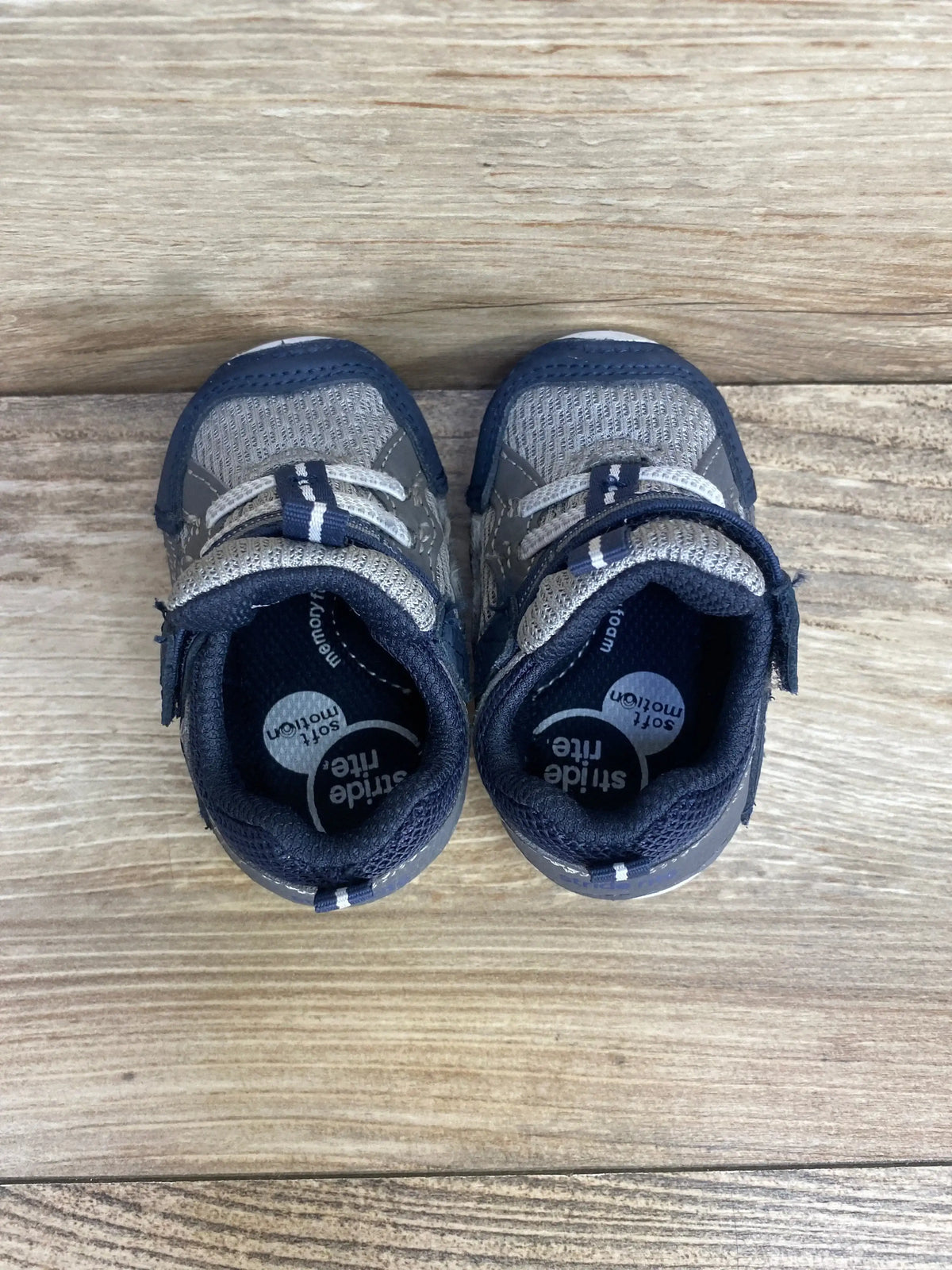 Side view of navy Stride Rite Soft Motion Kylo toddler sneaker showcasing hook-and-loop strap and cushioned sole on white background