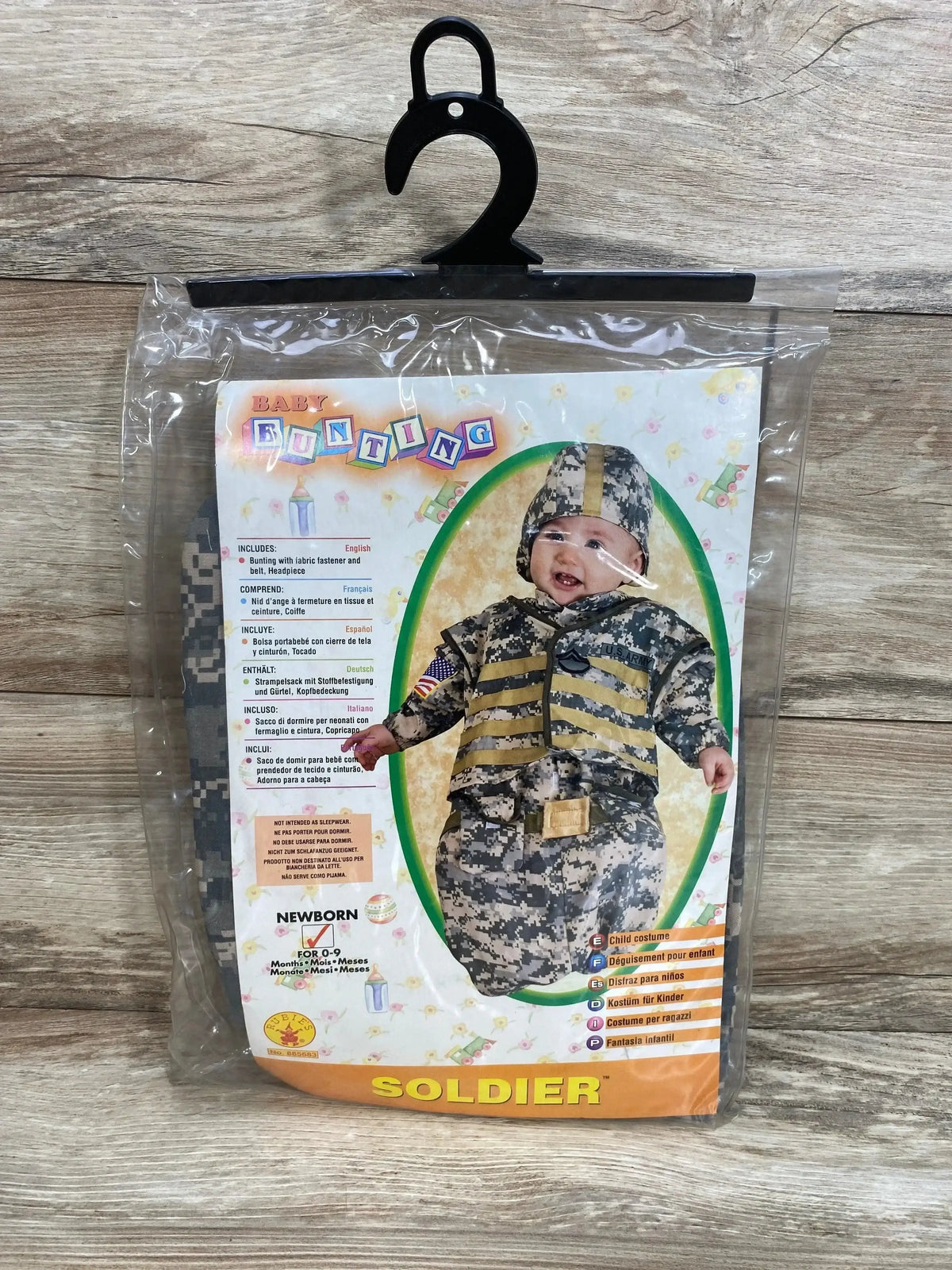Front of Rubie’s newborn soldier bunting costume, size 0-9 months, digital camouflage with hood and belt, packaged on hanger