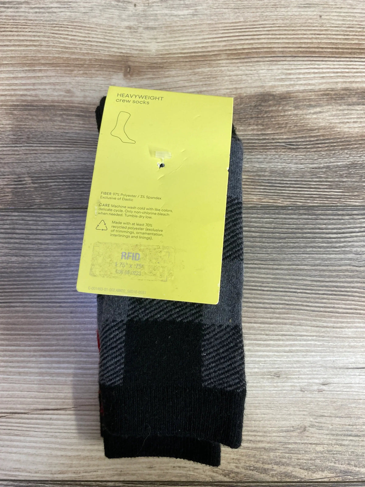 Pack of heavyweight crew socks with black and gray plaid pattern and yellow care instruction label