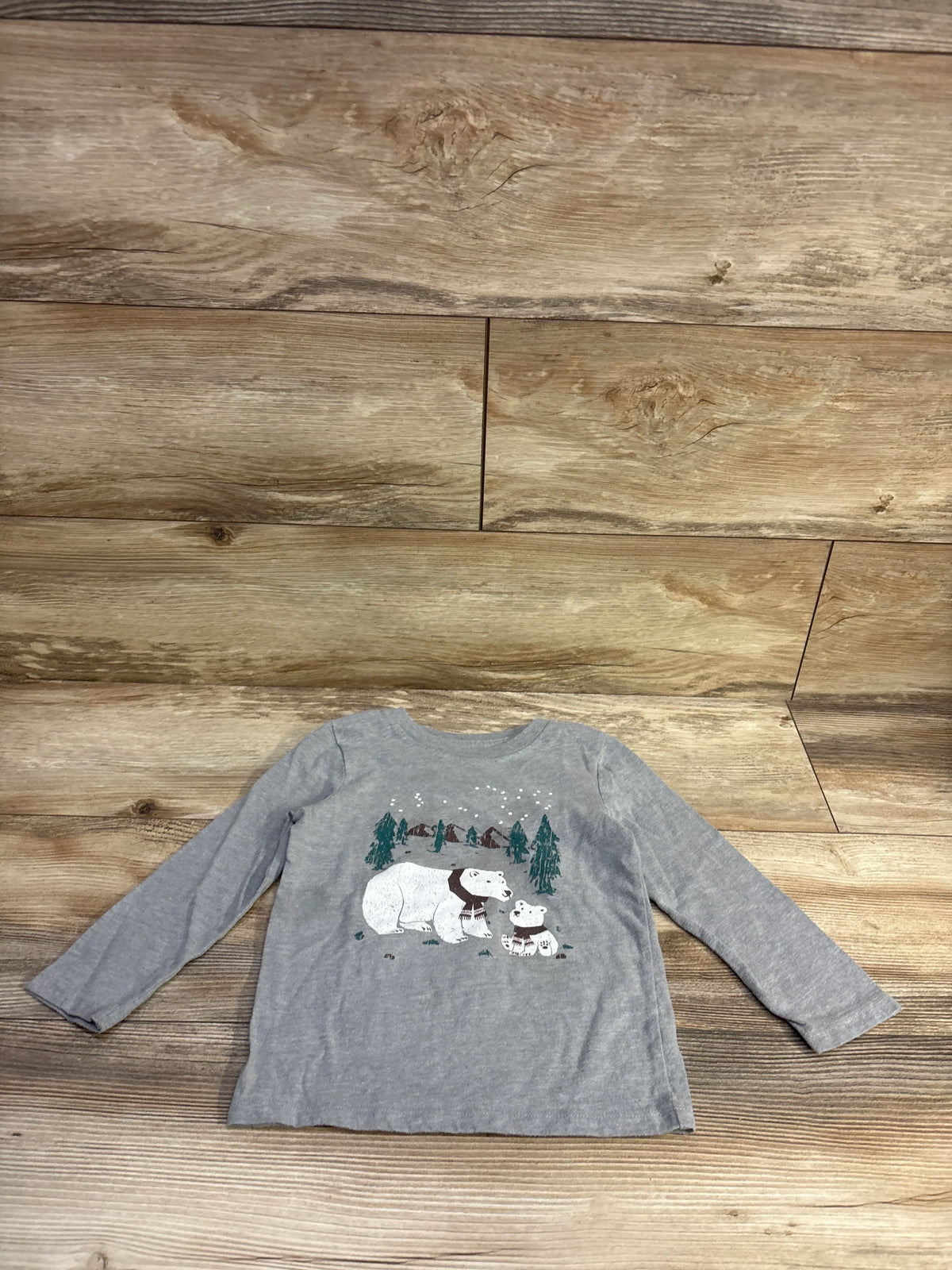 Front flat-lay of gray Cat & Jack toddler long-sleeve shirt showing polar bear graphic and crew neck on wood background, 3T