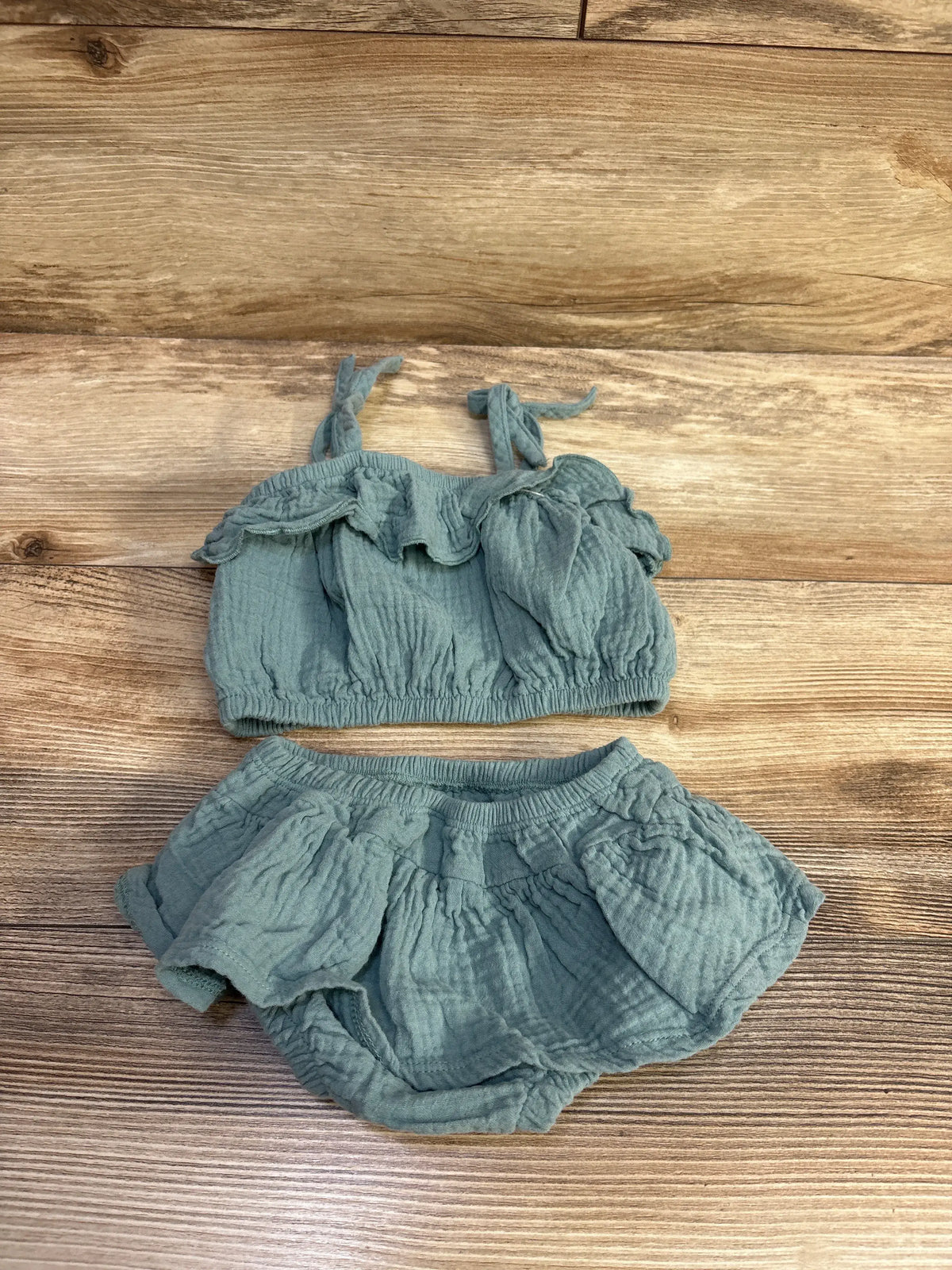 Flat lay of Grayson Mini 2pc Gauze Tank Top and Bloomers Set in green, with tie straps and ruffled edges