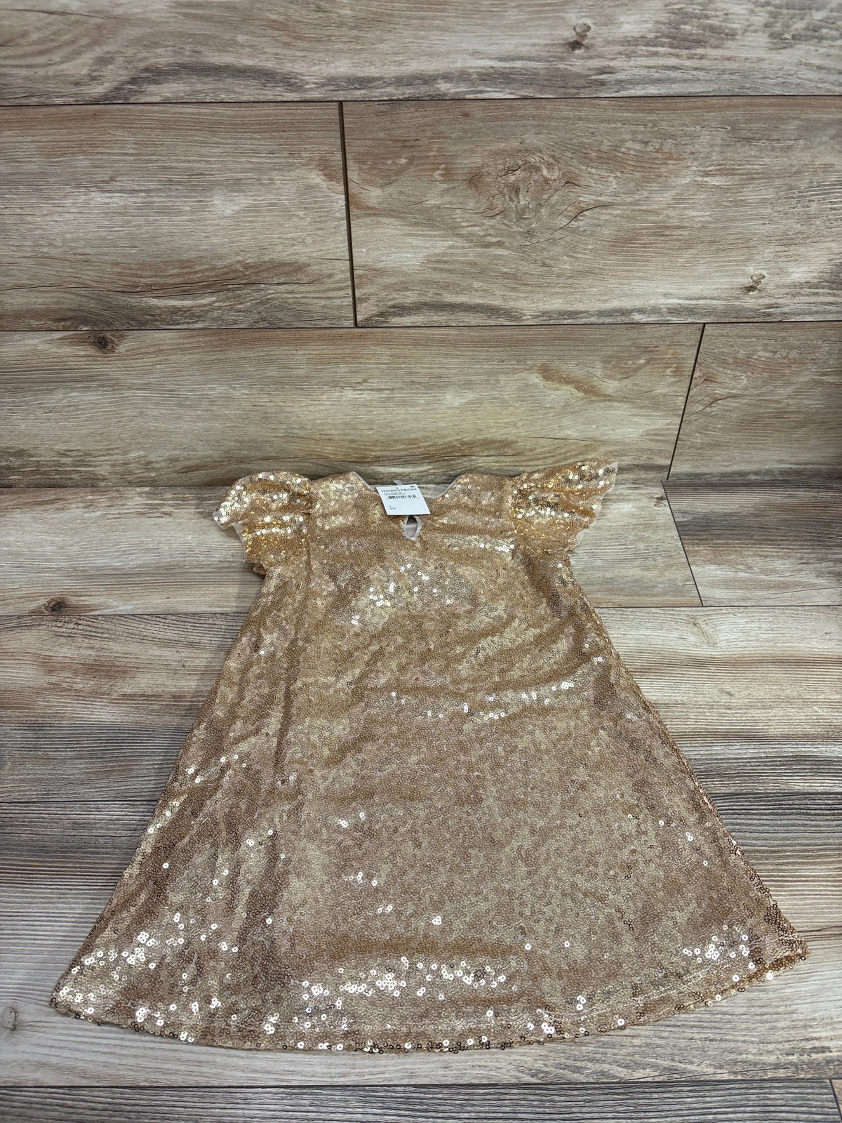 New gold Zunie sequin embellished A-line dress for toddlers size 4T on a wood background