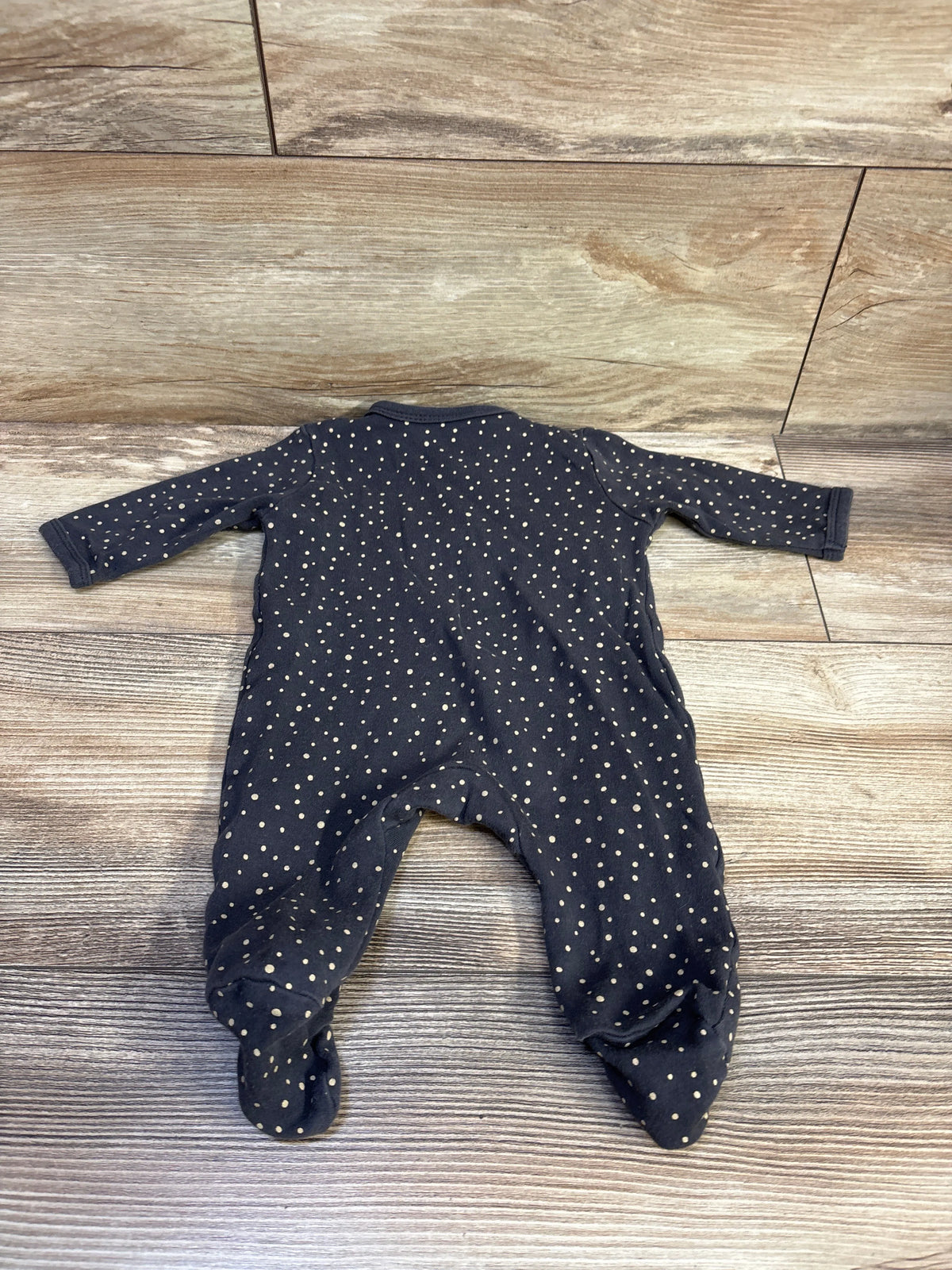 Side-snap sleeper in 3-month size, dark navy with cream dots and covered feet, laid flat