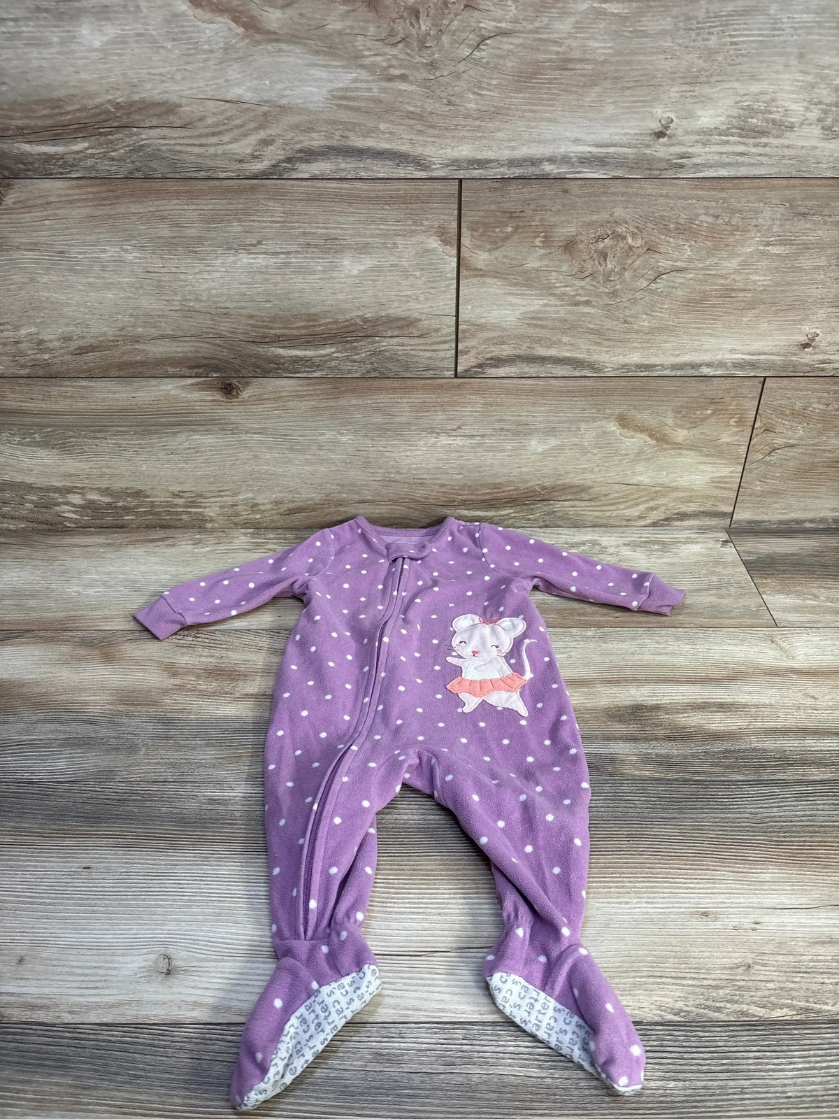 Flat lay of purple polka-dot Carter’s blanket sleeper, front-zip footed 6M with mouse applique on wooden floor