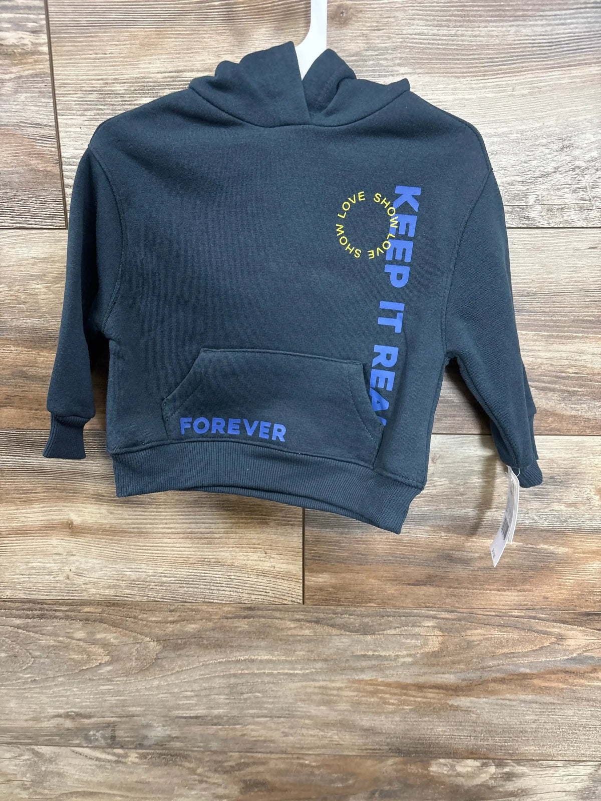 Navy blue kids hoodie with 'Keep It Real' graphic, kangaroo pocket, and 'Forever' text.