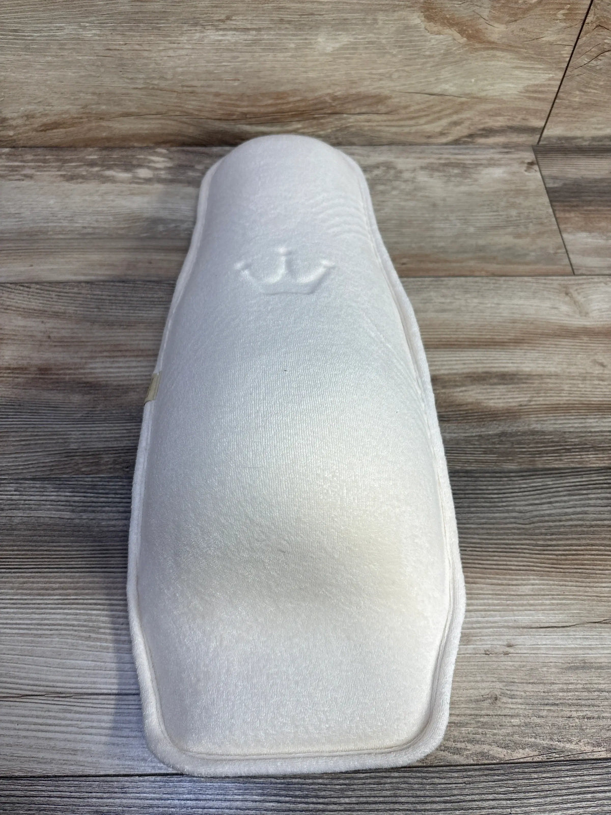 Top view of Alpremio Multifunctional Baby Feeding and Care Seat showing its white padded organic cotton and breathable mesh cover on a wood floor