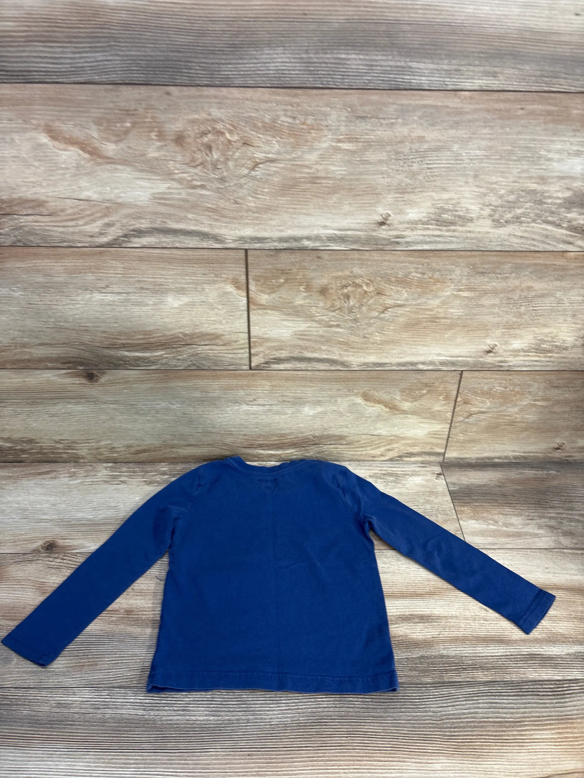 Front view of a navy Puma toddler shirt, size 3T, showcasing long sleeves with a wood-look floor background