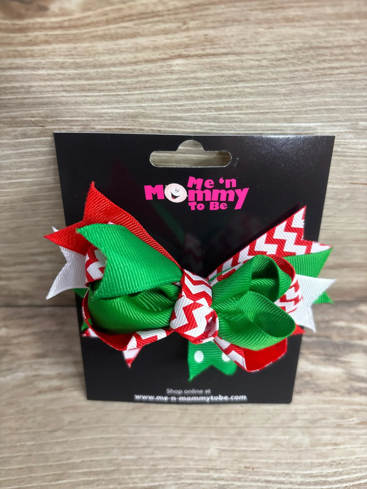 Festive red, green, and white holiday hair bow for kids, perfect for Christmas outfits and baby gear.