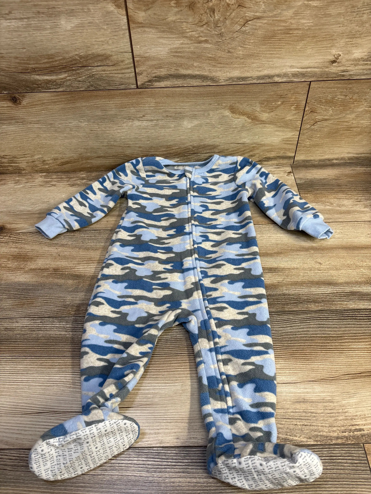 Kids Headquarters blue camo print baby blanket sleeper with footies on wood background
